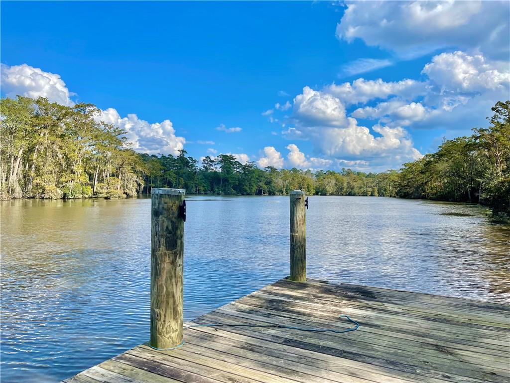 Large cleared Estate-sized lot in Tchefuncta Estates on the navigable Tchefuncte River with a fabulous dock and boat house with lifts. Build your dream home on one of the FEW riverfront lots in this sought after community with 24/7 security, Sheriff's Sub-Station, parks, marina and more. Optional Tchefuncta Country Club offers 18-hole golf course, dining, 24 hr gym, tennis, and swimming.