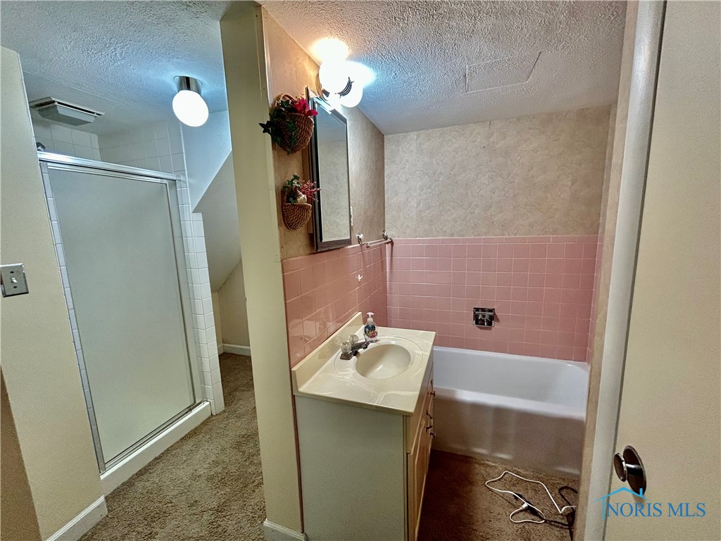 Downstairs full bath. Notice separate shower and tub.