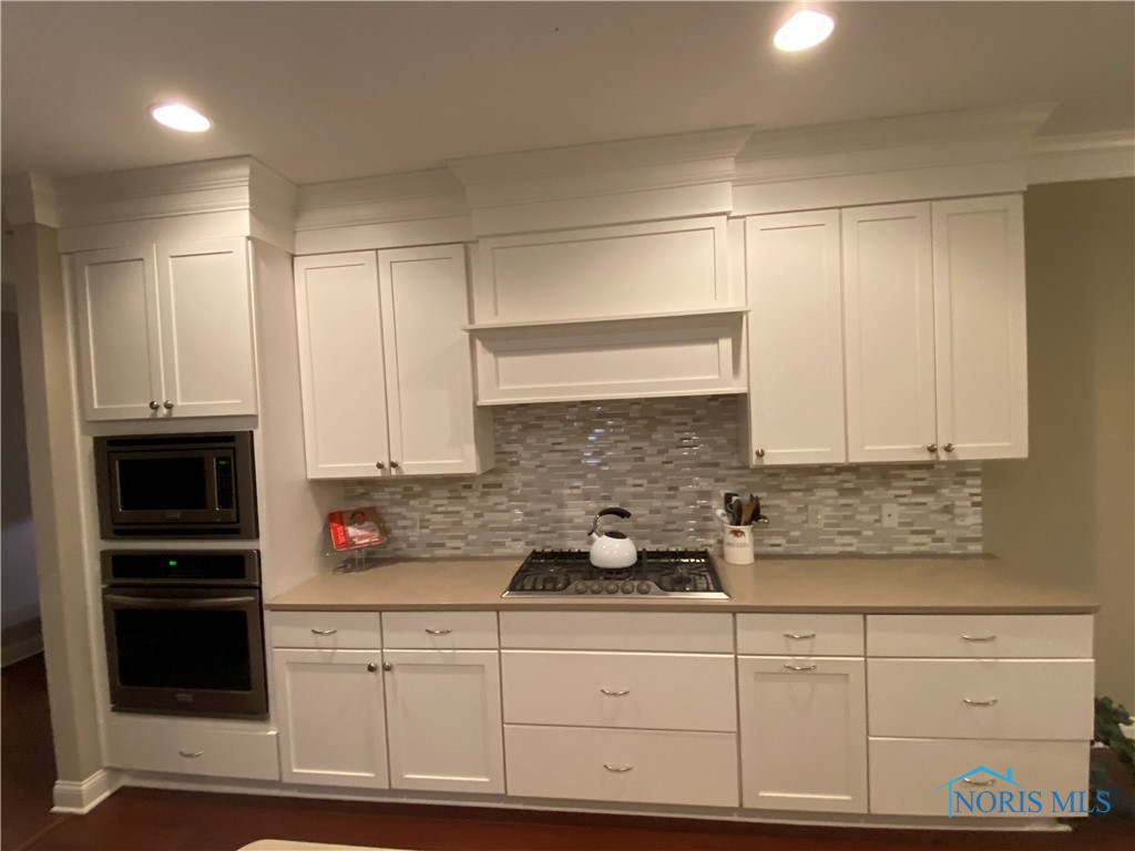 Beautiful kitchen with Quartz countertops, built in oven and microwave. Gorgeous white kitchen.