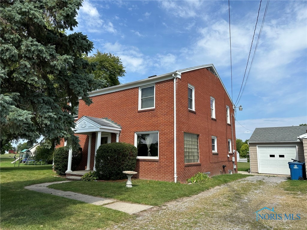 Here is a unique opportunity - this spacious home also includes an outbuilding with a kitchenette, half bath, garage space, and the perfect setup for a small business or office.  The home features hardwood floors, updated windows (2016), brick exterior, a nice corner lot, and a great location close to shopping, dining, and the school campus.  Come see the potential and possibilities.