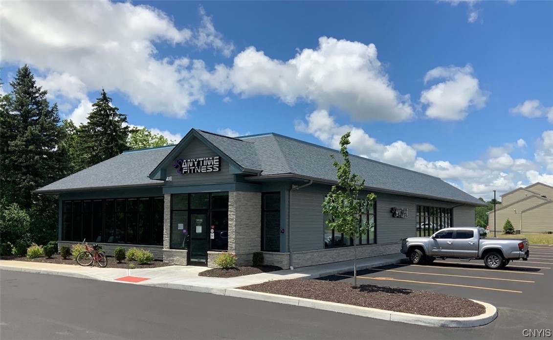 Four Year Old free standing 5,000 +/- SF high-end professional building on a beautifully landscaped parcel totaling 1.17 Acres. The building is located on the corner at 7165 Buckley Rd. & Red Barn Circle Rd, in Syracuse NY. The building was constructed in 2019 as an Anytime Fitness Center with an open free span design and no supporting interior walls. This design allows for a multitude of uses as it has more open floor space and an unobstructed view providing more room for people, furniture and equipment without requiring a larger building.  The current interior design is three large well-appointed rooms with two walls of windows providing lots of interior natural light along with three Offices and three Restrooms two having showers.
