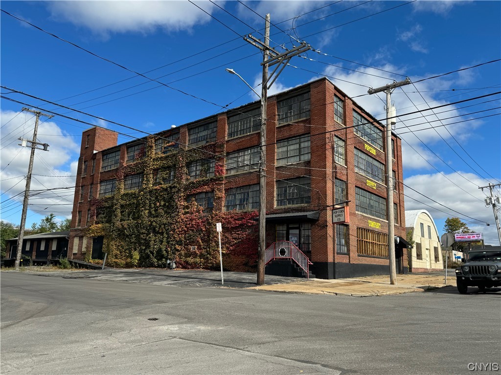 This four-story brick building provides 25,542 +/- SF on .21 +/- Acres with an additional .12 +/- Acre parking lot across the street. The first floor was most recently used as a Popcorn Supply Retail store. Upper levels were used for storage. This Building is a fantastic opportunity for redevelopment with its exposed Brick Interior and exterior, Large windows on three sides and its exposed huge Wooden Beam Ceilings on all four floors providing lots of character. The Ceiling heights are 12' with a Sprinkler system and Gas Heat. The entire Roof was sealed 5-7 years ago and in 2023 South end of the building was resealed. The building is in excellent structural condition. Potential uses Warehouse, Manufacturing, or Redevelopment.