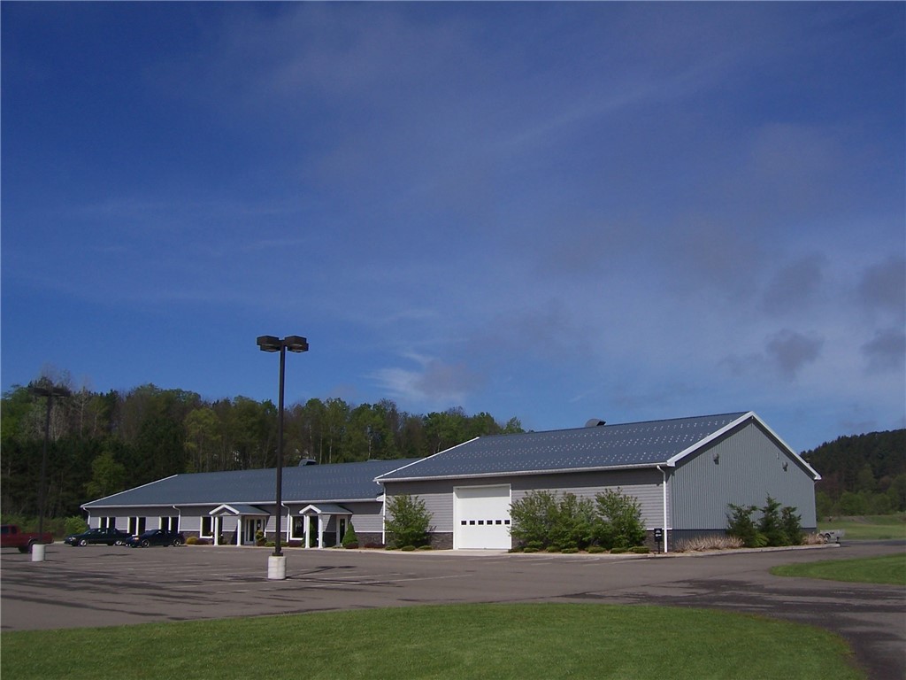 One-of-a-kind location!  Former automotive restoration / sales / service building of 20,000 square feet! PLUS 3-bay, 4,000 sqft operating car wash facility and business will transfer with the sale!  Instant cash flow!  A third 5,100+- sq ft building with 14' high doors is also included, and provides 2,600 sq ft of garage/warehouse and 2,500 sq ft sandblast area.  80+ acres of land zoned for residential, agricultural, and many commercial uses with Special Use Permit. Park in the 130 space lot and approach the building onto heated entry sidewalks.  Enter into a Class-A lobby/office/showroom of 9,100 sq ft of finished ceramic tile and a variety of species of wainscot walls in each room of different wood species-elegant and classy!  Includes  offices, conference room, showroom, break-room with kitchen/baths/shower, plus a parts/store room which easily converts to any use, and a 4,900 sq ft repair shop with radiant heat and secondary recycled oil heating as supplement.  Multiple overhead doors and 16' high ceilings create a versatile space for many uses beyond automotive!  The third wing of the building is a 7,000 sq ft clean room, machine shop, paint booth, detail, and mechanic's shop.