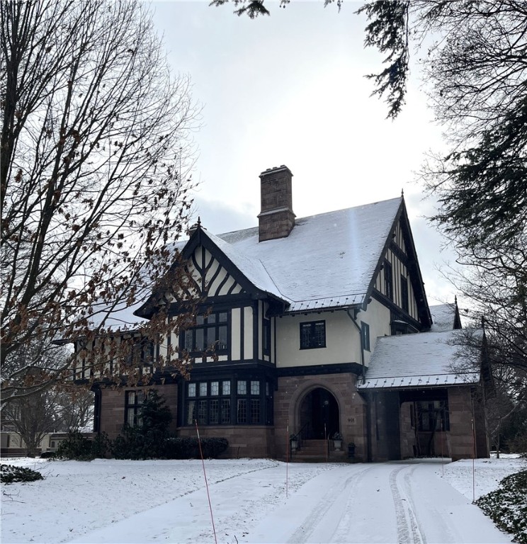 Elegant condo nestled in an 1859 Estate in the heart of the East Ave Pres District! A true embodiment of the Tudor revival style w/ oak paneled walls, coffered ceilings, arched doorways, intricate leaded glass windows, & natural stone & oak flooring that create an ambiance of timeless sophistication. The light-filled LR is accentuated by a grand stone FP & a stunning crystal chandelier. W/ its arched cabinetry, w/b FP & oak walls, the library is a cozy retreat for book lovers. The breathtaking DR has the ambiance of a conservatory, featuring walls of leaded glass & travertine stone floors. Leaded glass doors open onto a private patio w/ custom awning, overlooking an English parterre-style garden. The kitchen is a chef's dream, equipped w/ granite counters, large island, custom cabinetry & high-end SS appliances. For more casual moments, a cozy informal den awaits, & a convenient 1/2 BA is perfect for guests. The luxurious primary suite is a sanctuary w/ a FP & an ensuite BA boasting heated marble floors, custom vanities, & a jacuzzi tub that overlooks the beautiful gardens. 2 add’l. BRs & BAs complete this remarkable home, offering elevated style & comfort in every corner.