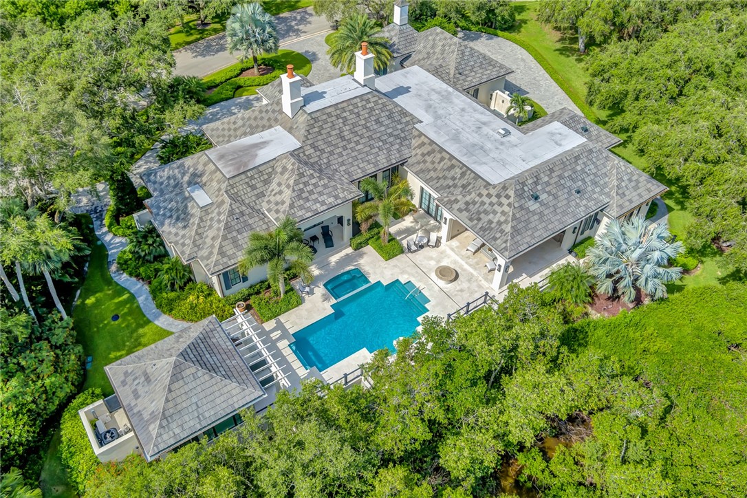 Majestic 5BR/6.5BA, 7,121+/- GSF estate exudes John's Island Perfection in Meticulous Architecture & Design.  FULL Club Membership INCLUDED w/ Board approval,  Outdoor/Living Embraced, Tropical Landscaped Pool, Summer Kitchen, Cozy Fire Table, Encompassing Pristine Nature Preserve along the tranquil Indian River.  Privacy is Paramount at this Prestigious address nestled on 1.56+/- acres.  Impressive Chef's Kitchen with a Spectacular Cascading Marble Island.  Large Circular Driveway, 3+ Car Garage & Dock along John's Island Sound. Quick Ingress/Egress via West Gate.. Sizes approx/subj to err.