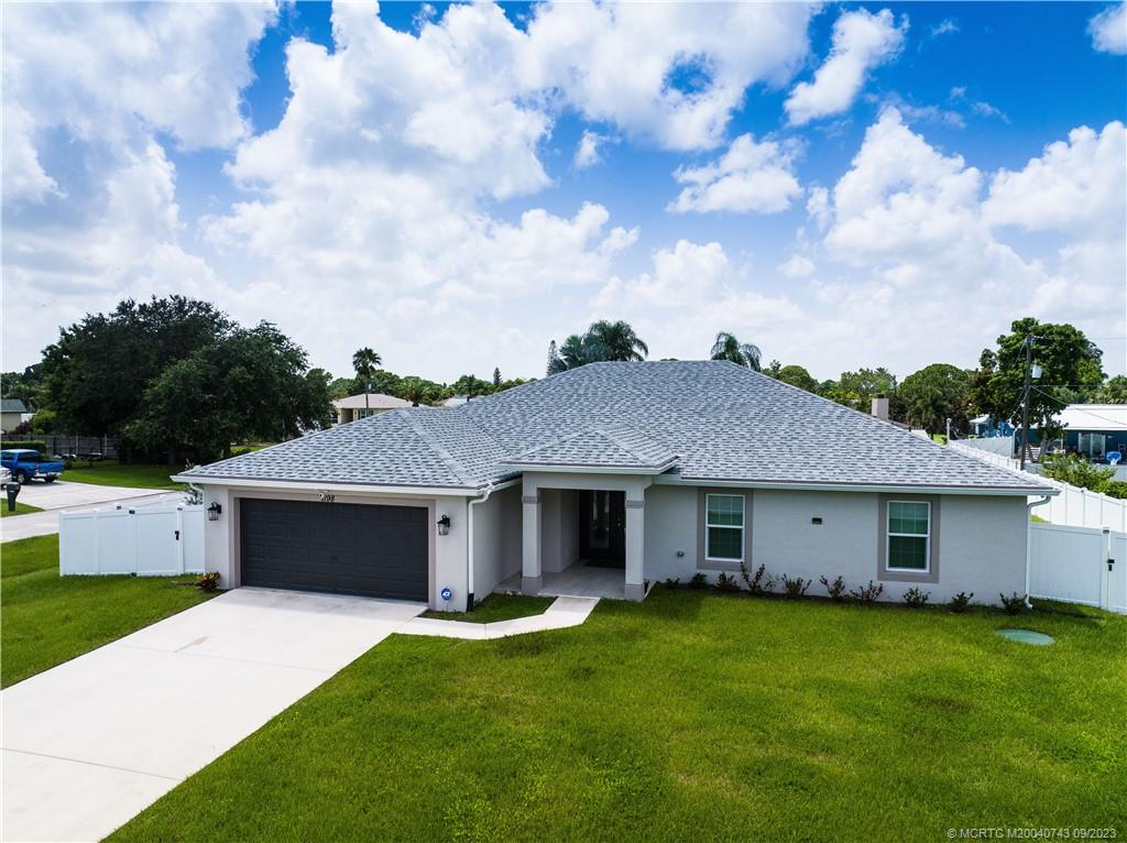 Why Wait For Months for a Home to be Built When You Can Have This Beauty W/ Many Additional Upgrades Immediately! 1- Yr Old Gorgeous 4 Bedroom, 2 Bath, 2 Car Garage Home Situated on an Oversized Corner Lot W/ Potential Side Yard Access for Parking an RV, Boat or Camper. Tiled Porch & Double Entry Glass Doors Welcome You Into This Great Room Design, Providing Spacious & Open Living W/ 3 Private Bedrooms and the Private Owner Suit for Comfort of Your Family & Guests. The Well Appointed Kitchen Features Stainless Steel Appliances, Soft Close Cabinetry, Stone Counter Tops, Decorative Tile Backsplash & Pantry. With the Expansive Screened & Tiled Lanai & Privacy-Fenced Back Yard, You Can Enjoy Outdoor Living, Play & Entertainment for All. Other Features Include Full Impact Glass, Lawn Irrigation System, Ample Driveway & Room for a Pool. NO HOA. Super Convenient & Easy Access to I-95, Turnpike, Shopping, Dining & Medical Facilities.