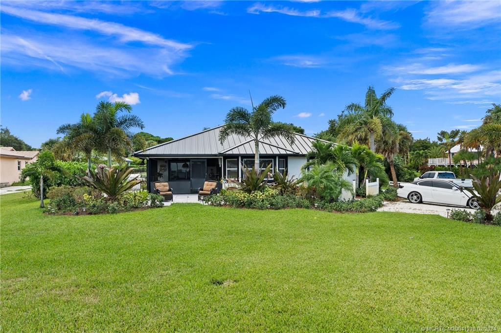 Welcome to this exceptional property in the sought-after location of Indian River Dr in Jensen Beach. This beautifully renovated home offers breathtaking views of the Intracoastal, making it a dream haven for nature lovers & those seeking a serene & picturesque lifestyle.  As you step inside, you're greeted by an open concept layout. The kitchen is a chef's delight, featuring stylish shaker style cabinets, sleek quartz countertops, & ample storage space. One of the standout features of this property is the renovated main home that boasts 2 spacious bedrooms & 2 exquisitely updated bathrooms. Enjoy the comfortable tile floors & marvel at the abundance of natural light that floods the entire space. Additionally, there is a separate 1 bedroom, 1 bath attached quarters that comes complete with a kitchenette, living room, & dining space - perfect for accommodating guests or generating rental income. Not to mention, the property offers a convenient 2-car carport & a stunning new metal roof.