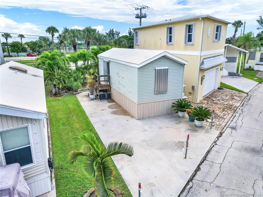 Here's your chance to grab a lot with a potential ocean view! Soak up the island sun with this desirable spot in beautiful Holiday Out. Just steps to the underground tunnel and beach/pool access! This lot is in an amazing location in the community. A future 2 story build will have ocean views, as seen in the pictures. The existing one bedroom, manufactured home is in EXCELLENT condition. Never rented. Full Storm Shutters. Sitting/Entertaining area in the back is shaded by trees.  Enjoy all of the excellent amenities that Holiday Out has to offer! Pickleball, Shuffleboard, Bocce Ball, Horseshoes, Beachside Pool, Private beach access, BBQ Grills, Library, Pool table/Ping Pong, Clubhouse Events, Gated entrance, and on-site management.