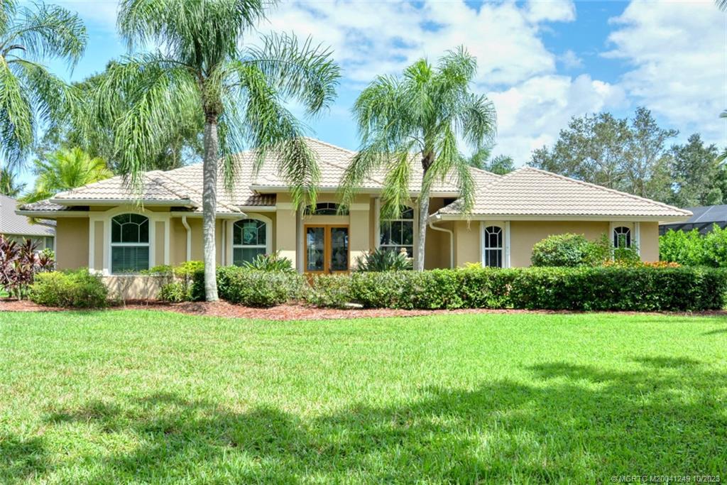 Brand NEW tile roof being installed on this beautiful home in desirable Lake Grove. Three Bedrooms and 2.5 baths on an elevated half acre with lake views. Salt water pool/spa. Generous kitchen with center island, granite countertops, 42'' cabinets and open to family room with plantation shutters. Master bedroom ,den/office on opposite side from two remaining bedrooms w/ shared bath. Recent improvements include a 24k full house generator w/ inground 500 gal tank, electric storm shutter/screens for lanai and patio doors, two new impact windows on front and accordion shutters for all other windows. Storage shed in back will convey. Pool heater+hot water heater recently replaced. Pool lights not operational. Close to Palm City amenities and highly rated Palm City schools. By appointment only