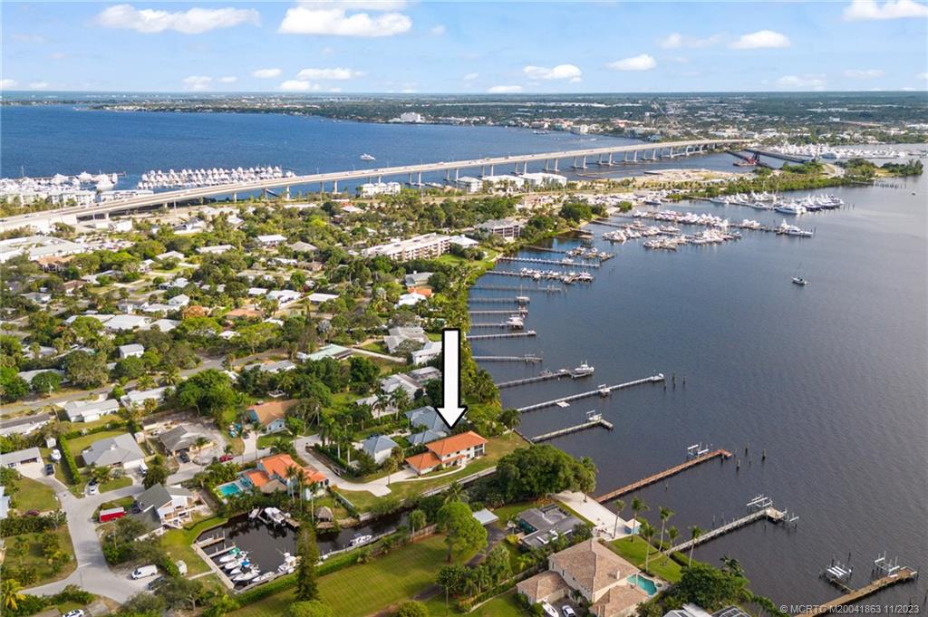 Discover this WIDE WATERFRONT POINT LOT with MILES AND MILES of WATER VIEWS and 285ft +/- of Water Frontage! RARE SOUTHERN EXPOSURE. Exceptional Water Views from nearly everywhere in the home. Great dockage to harbor 2 large vessels + lift! DEEP WATER! The home sits on the Saint Lucie River and a canal that accesses the Sunset Estates Private Marina. Wide Water, Canal, AND Marina views! Minutes to Downtown Stuart and beaches. Only 1 owner since NEW! 4 bedrooms, 2 full and 1 half bathrooms, with large veranda off the upstairs Master Suite, and large screened porch off the living room. Real Clay Barrel Tile roof. BEST LOCATION for 4th of July fireworks. NO HOA-NO RESTRICTIONS! Amazing short-term rental possibilities! Make an offer! Showings by appointment only. Private Property.