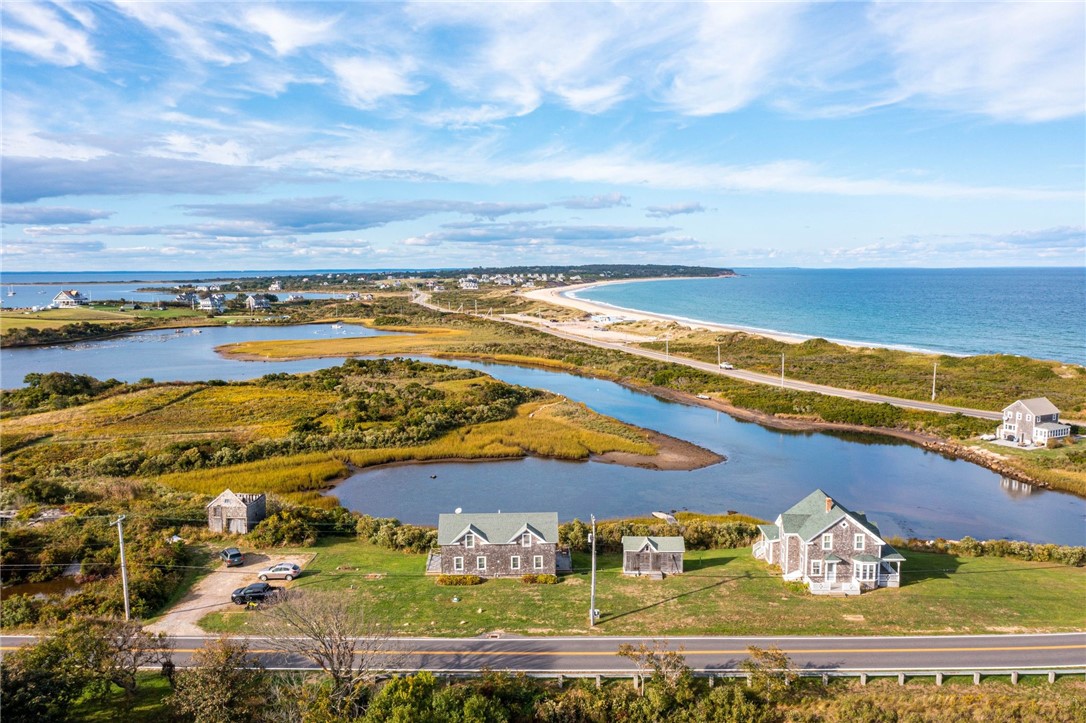 This iconic waterfront property is a rare opportunity to experience coastal living at its best-Block Island style.  Set on 1.58 acres and surrounded by Trim's Pond, this unique property consists of a classic 4 bedroom, 1.5 bath renovated 1873 farmhouse with views from every room.  The house and kitchen/baths have been tastefully renovated while still maintaining the character and charm of an older home.  Enjoy sunrise/sunset skies and the beauty of Trim's Pond from the wraparound porch.  A two unit duplex provides income-each unit has an open living/dining/kitchen first floor-spiral stairway accesses the bedroom and full bath on the second level.  Small building once used as a toy store, "The Mouse House" is waiting for a new owner's ideas.  Rebuild the barn to use as a garage/storage building.  A 30' x 50' slab is on the rear of the property with potential for additional building pending town/CRMC approvals.  Walk the short path off the north side of the house to a boat dock.  Perfect for taking a dinghy, kayak/paddle board or small water craft to the Great Salt Pond.  This tranquil retreat is centrally located across the street for "Baby Beach' and an easy walk to Old and New Harbors.  Conservancy land borders and protects this setting.  Come be captivated by shore birds, water sport activities and the sights and sounds of the ocean.