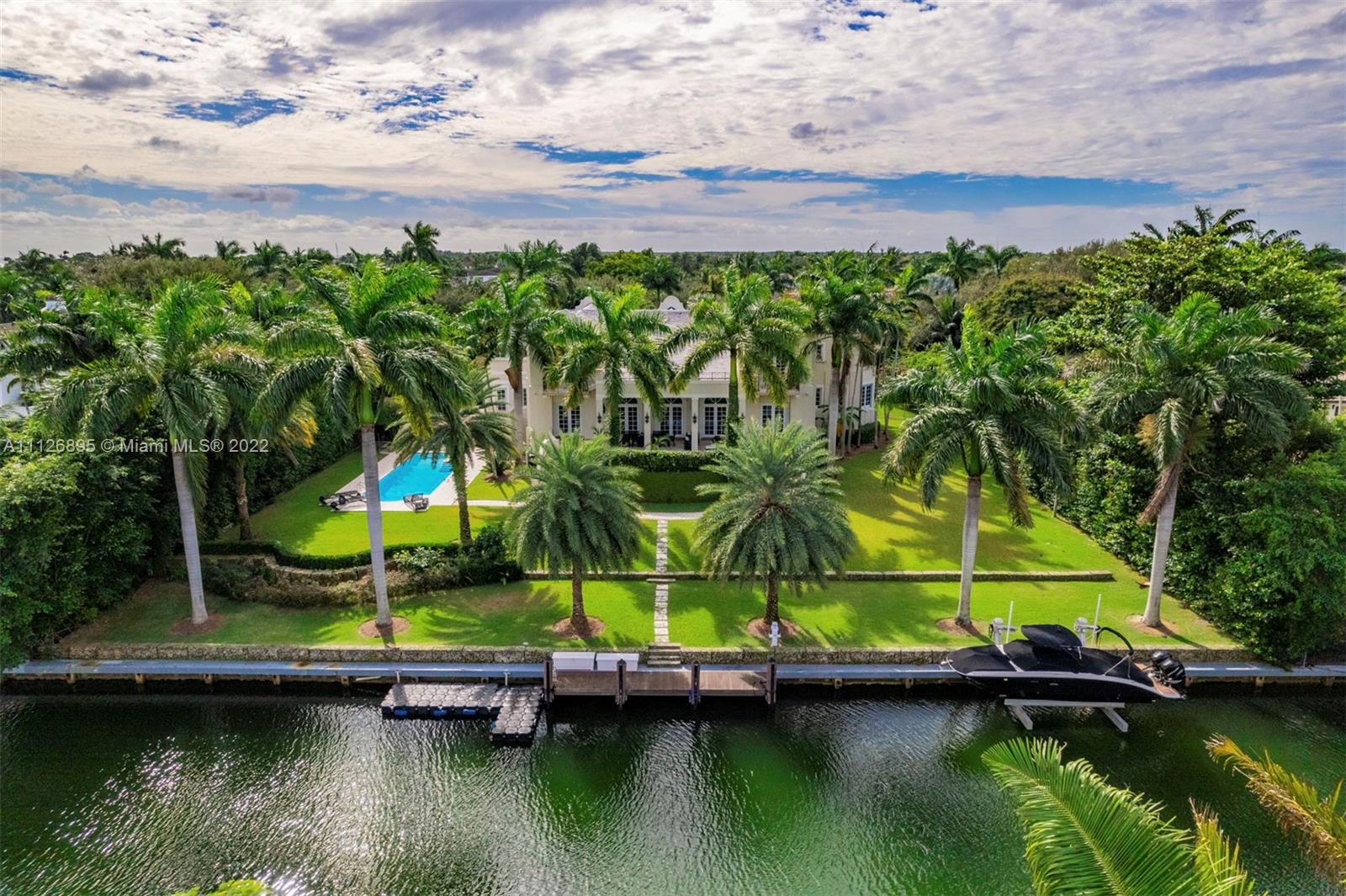 585 Arvida Parkway is a spectacular 12,102 Sq.Ft. waterfront residence on beautifully landscaped grounds in the prestigious community of Gables Estates. Featuring east and west wings, the exterior facade melds Dutch and Island influences. The elegant interiors include double height ceilings, stunning living and formal dining rooms, and chef's kitchen with Gaggenau appliances and breakfast area. The main suite has a luxurious marble bath with a long-mirrored vanity, jacuzzi and multi-jet shower, and two walk-in closets. Other special features include an elevator, family room, library, two fireplaces and 4-car garage. The resort-style outdoors have covered terraces, a pool and 180 feet of waterfront, with direct access and no bridges to Biscayne Bay.
