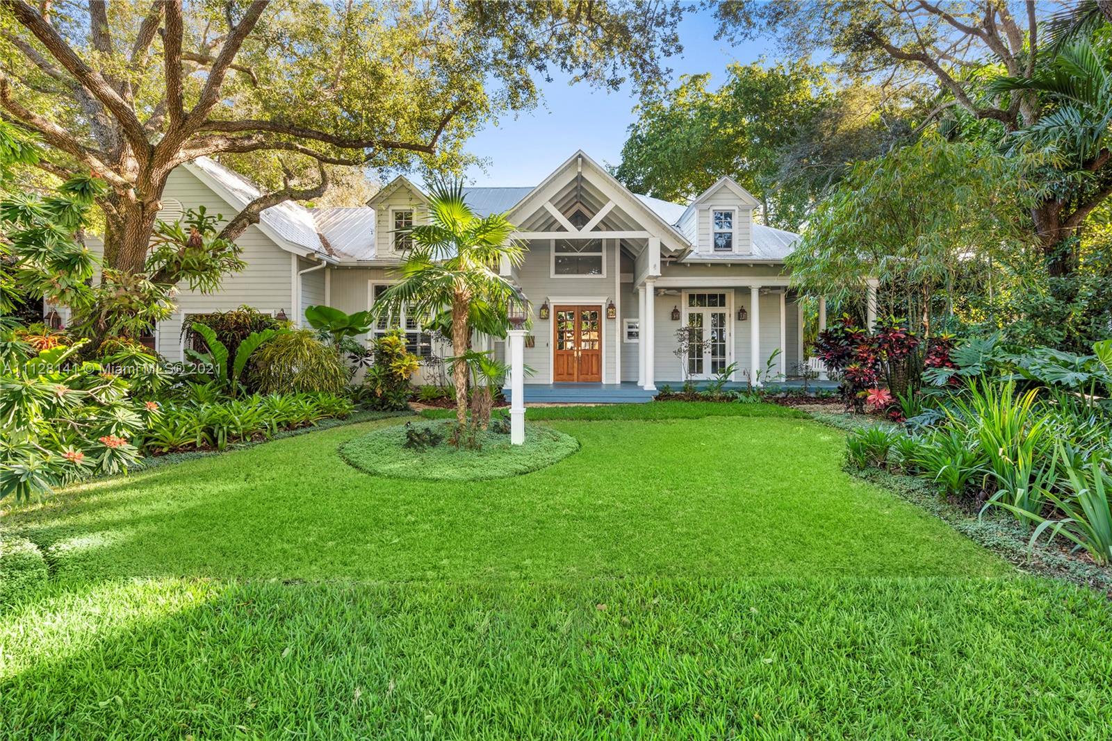Gorgeous, graciously scaled Nantucket-style home in coveted, close-in High Pines. Wide, covered verandas invite indoor/outdoor SoFla living. Modern, pristine light-flooded interiors w/volume cypress ceilings, 5” plank teak floors, bespoke woodwork & craftsman finishes. Gourmet kitchen w/top-tier appliances, gas cooktop & butler’s pantry; formal dining rm; great rm anchored by stately fireplace opens to loggia/summer kitchen & pool. Primary suite offers tropical garden/pool views; all bdrms en suite +office/optional bdrm; custom closet systems thru-out. Add’l rms include full laundry; vast, easy-access attic. Oversized 2-car garage w/safe rm; Chicago brick driveway, paths & patio; 16K generator. Mature oaks & palms frame the distinctive residence. Mere blocks to shops, dining, parks & more!