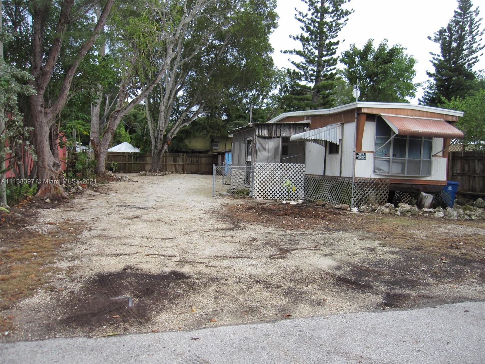 This is a single wide mobile home. 2/1, 720 sq/ft. on a spacious and obstruction free 50w x 102d Lot. (5141 sq/ft). Home is livable but could use some TLC or remove and build your dream home. Rogo applied for and should be received in January 2022. Great location in front of a National Preserve and within a casual walk to the popular National State Park of Harry Harris with boat ramps, picnic areas, beach, playground, baseball field, basketball, fun place. Plantation Key Schools and Coral High School just 3 miles close. This could be one of the rarest and cheapest investment opportunities still available in the keys. NO HOA.  No restrictions! Store your RV or boat. Come and enjoy a piece of paradise.  Land conveys with purchase! Call listing agent today!