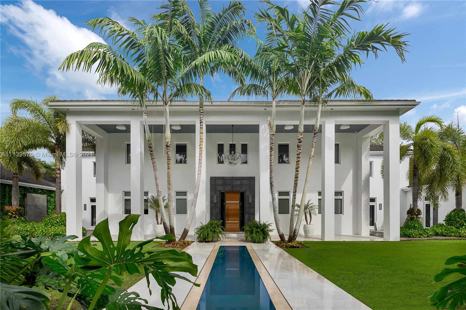 Nestled on an acre lot, this custom 2-story estate is located on a quiet cul-de-sac in one of Miami’s most prestigious neighborhoods, Ponce Davis. Guests are welcomed by a stunning reflection pool and double height foyer with winding staircase. Massive Master Suite boasts sitting area, private balcony, impressive custom closet, spacious bathroom with oversized shower and separate tub. Modern Kitchen with eat-in island and high-end appliances. Luxurious dining room with wine cellar and formal living room. Completely gated with lush landscaping, Koi Pond, multiple courtyards and water features create an ultimate private enclave. Multiple balconies and covered patio overlook the infinity edge pool. Additional features include media room, office, elevator and 6 car garage.