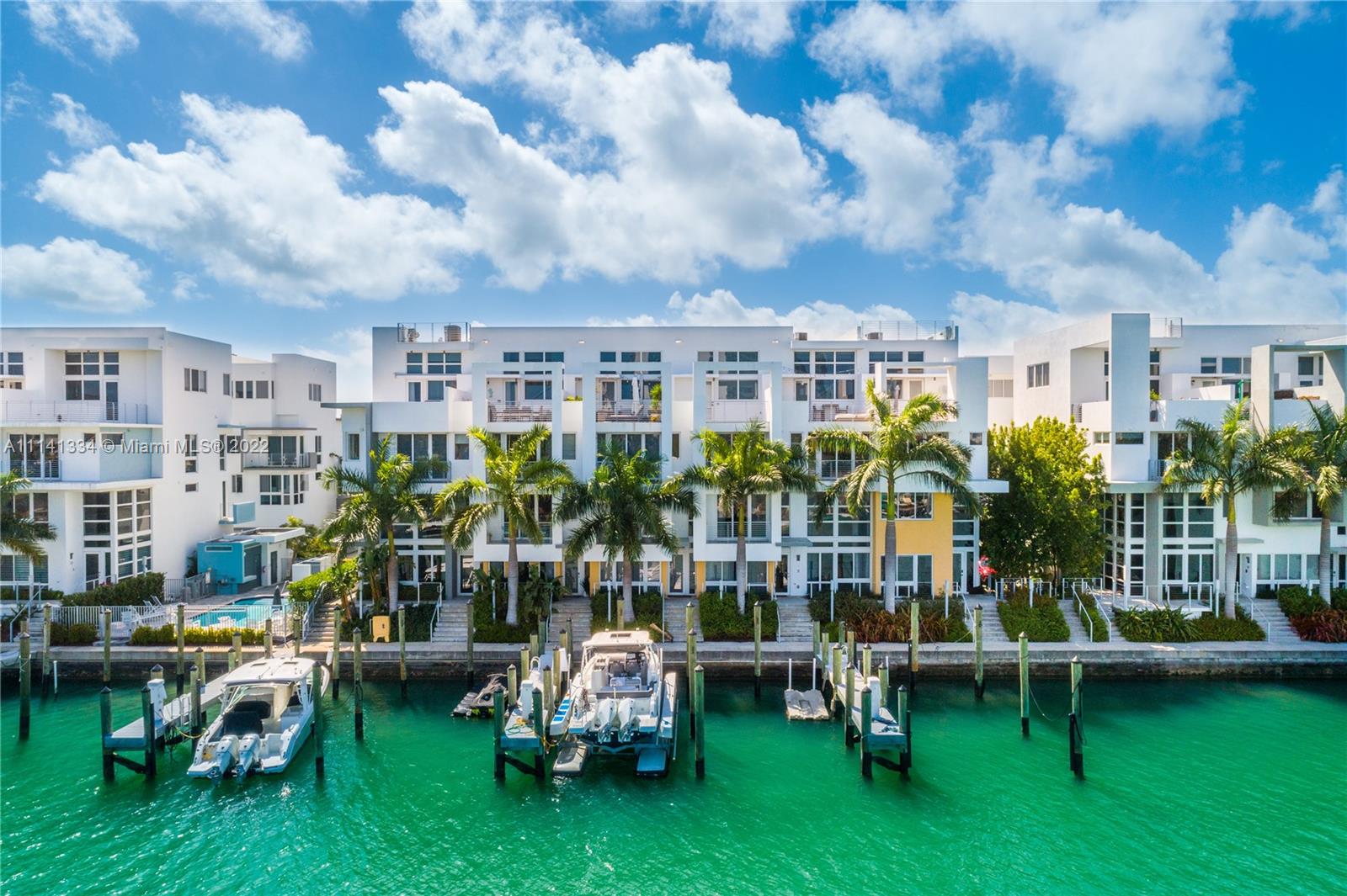 Built in 2016, Live the Miami dream in this beautiful 4 story waterfront townhouse. Located in Iris On The Bay featuring 3 bedrooms with private balconies, 3.5 bathrooms, private elevator, modern European kitchen, laundry room, rooftop terrace with plenty of space, and spacious 2 car garage. The specific location of this unit provides more open water views. Water access is only within a few steps from your door to the dock. The private elevator provides amazing convenience for all floors within the home. The property is located a few blocks from beach, across from normandy golf course, tennis courts, children's playground, soccer field, restaurants, and shopping.