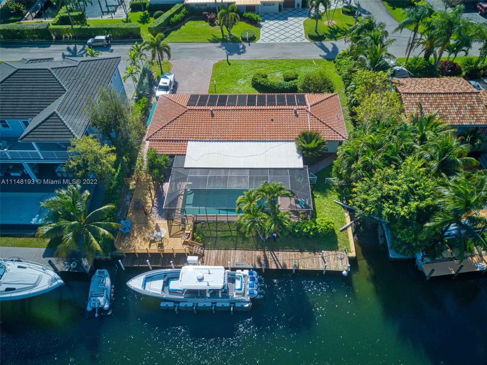 Unbelievable waterfront property with NO FIXED BRIDGES only 4 lots off the Intercostal. Deep canal, 100' waterfront that will accommodate an 80' boat. 3 bedroom\3 bathroom\1 garage\screened patio\salt water pool\fenced backyard. Boat ramp on property. 
Homesite will easily accommodate a custom new construction estate with 4600 living sqft. The home can be sold with the approved plans.
Walking distance to restaurants. PRIME LOCATION.