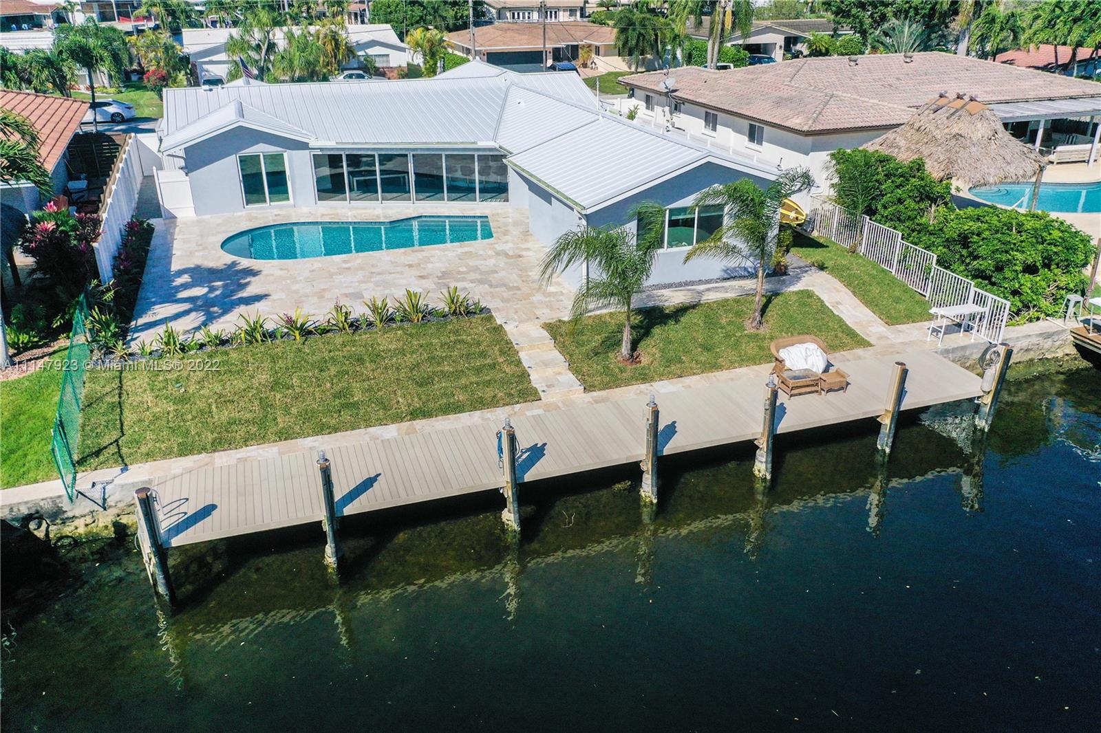 Beautiful 4/3 Waterfront Home 2297sqft (see Office Remarks), which includes an In-Law suite with a private entrance that has all been completely remodeled in 2020/2021. New Aluminum Roof, Plumbing & Fixtures, Electric, Kitchen, Appliances, HVAC, Pavers in Front & Backyard, Pool, Dock, Wooden Shaker Cabinets & Quartzite Countertops in Kitchen and Bathrooms, Flooring, Motorized Blinds, Impact Windows & Doors, Irrigation, Landscaping, Garage Cabinetry & Flooring, Dock & (10) Camera Security System. List price includes furniture as seen in the pictures. The In-Law suite is on a split HVAC system with separate thermostat, kitchen & a modern Murphy Bed that converts into a couch when not in use as a bed, currently tenant occupied $1200/month, lease expires 02/28/22.