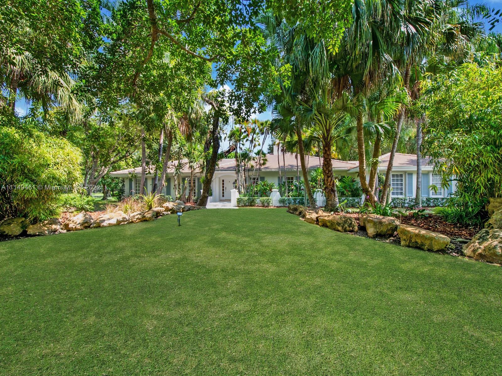 This beautiful single-story renovated home on historic Old Cutler Road in South Gables is within minutes to top-rated schools, Matheson Hammock Park & Marina, and Fairchild Tropical Botanic Garden. It has eye-catching curb appeal with lush tropical landscaping including multiple fruit trees and mature oaks, and is ideally situated on a large corner lot on a cul-de-sac side street. In addition to its sought-after location, this lovely home has 5 bedrooms with 4 bathrooms including a cabana bath, grand foyer entrance, double-sided fireplace shared by the formal living and family room, formal dining room with architectural details, family room with built-ins and wet bar with seating, spacious kitchen with ample storage and counter space, island seating, and breakfast area.