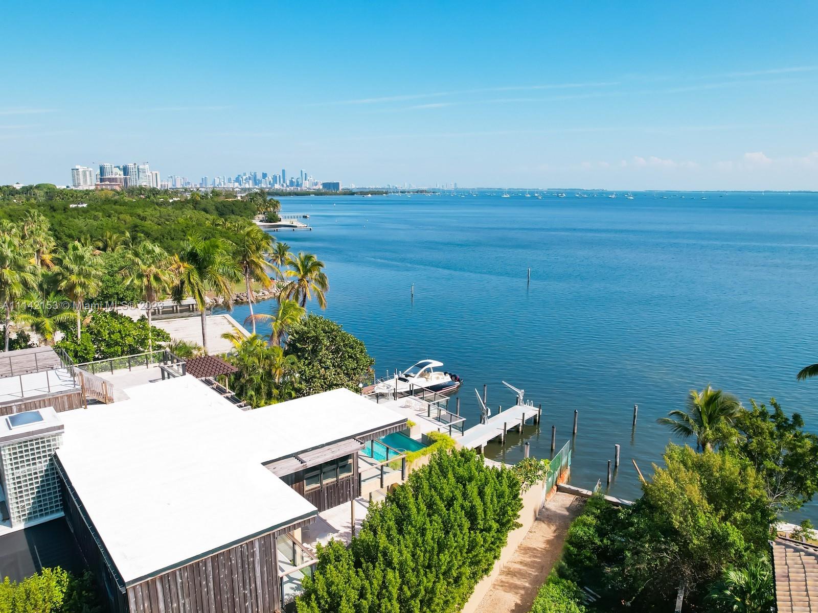 Magnificent wide direct bay view.    Main level is approx., 17 feet above sea level which creates some of Miami's best views from a single family home. Multi level living with glorious ocean, bay and city views are breathtaking. One of Coconut Grove’s most charming streets lead up to the private compound.Four bedrooms plus two offices, 5 1/2 baths, great room open concept, huge entertainment deck that allows great indoor outdoor spaces, new dock that can handle up to a 30 foot boat with approx. 4 feet of draft at low tide. Live the very special Coconut Grove lifestyle on Biscayne Bay.
