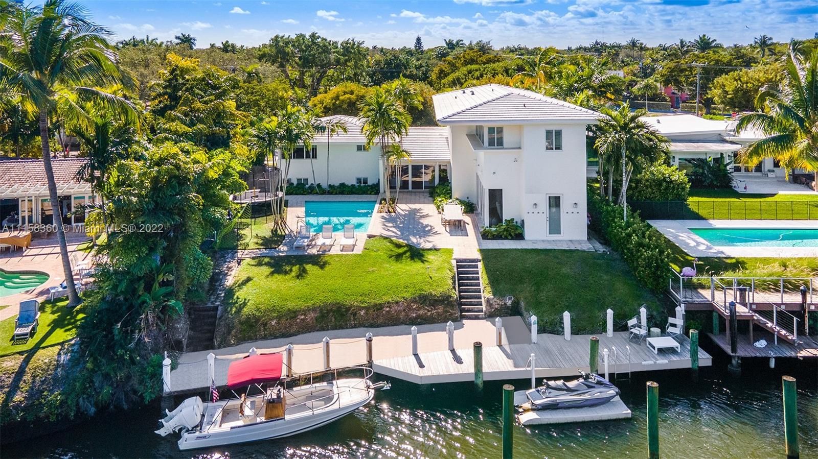 Bright, chic & renovated waterfront home built by famed architect Wahl Snyder w/ soaring ceilings, heated pool & no bridges! Located in guard gated and family-friendly Belle Meade! High elevation, flood insurance is only $700/year. Move-in ready, gut-renovation in 2015 by design firm DKOR w/ $400K+ in additional improvements made in 2020. Open & spacious layout w/ brilliant flow from the grand entryway featuring 27 ft ceilings to formal living room, dining room, eat-in kitchen & family room each w/ 12+ ft ceilings, custom office plus bonus room/gym equipped w/ laundry room & ample built-in storage throughout. The grand primary suite features abundant walk-in closets and custom spa bathroom designed by Ann Sacks.