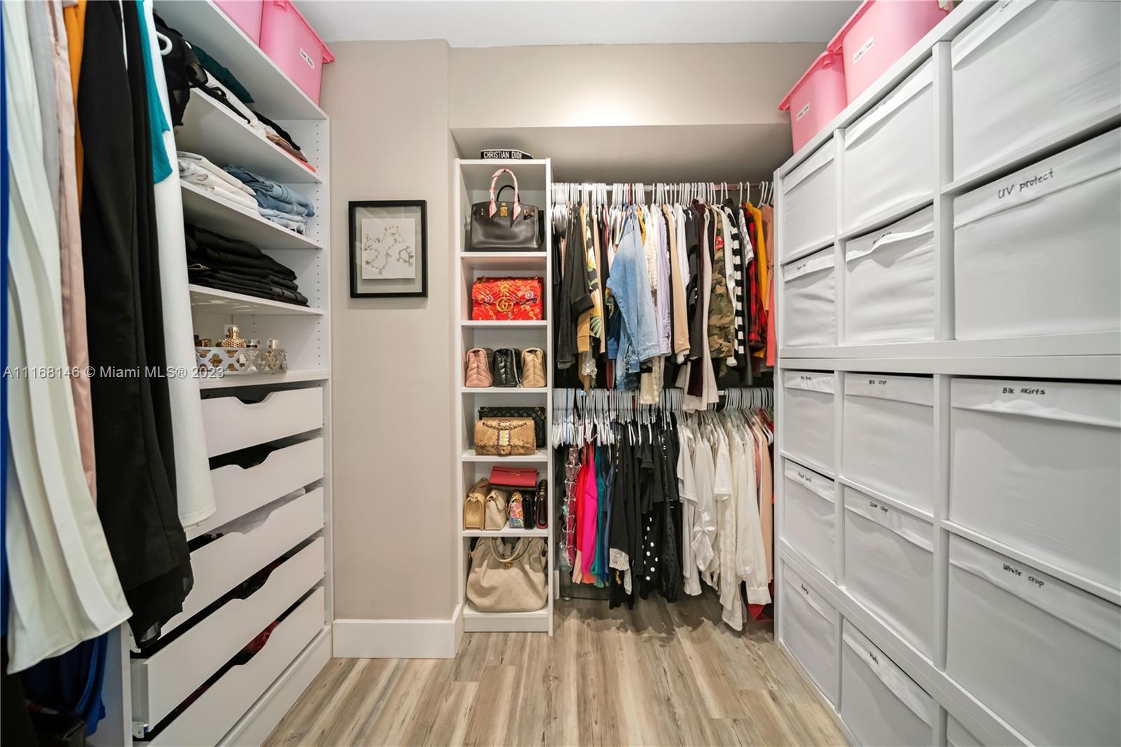 huge walk in closet with built in drawers and shelves