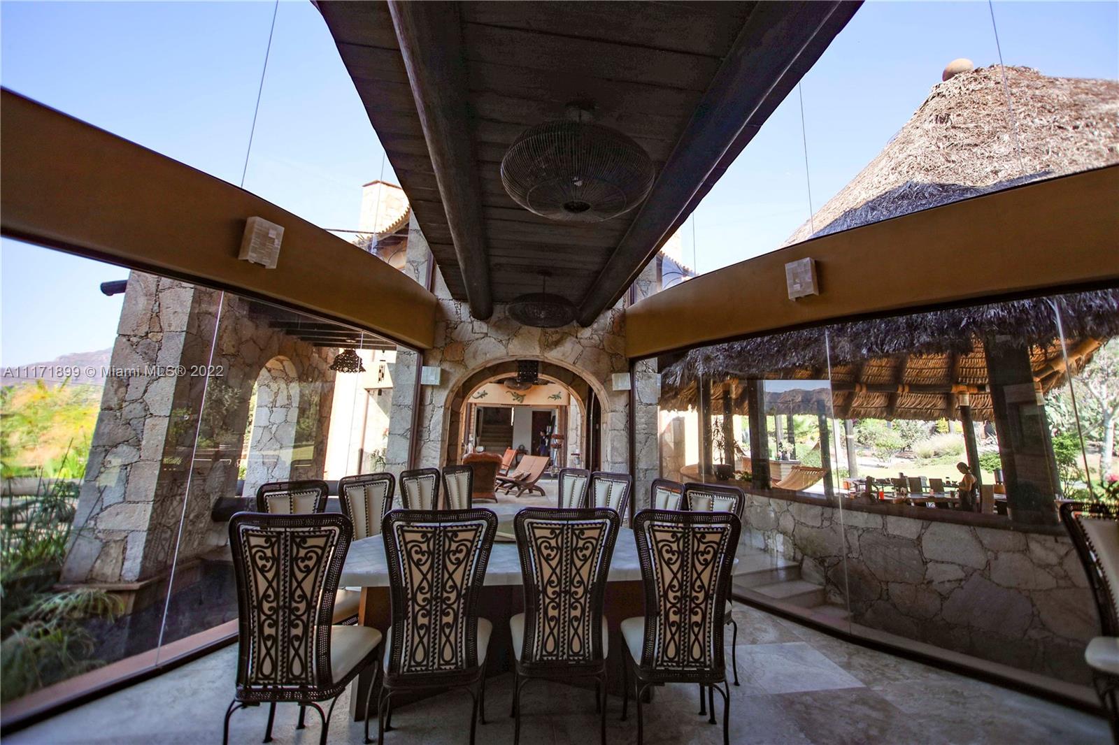 Formal dining with panoramic views of the mountain & pool area.