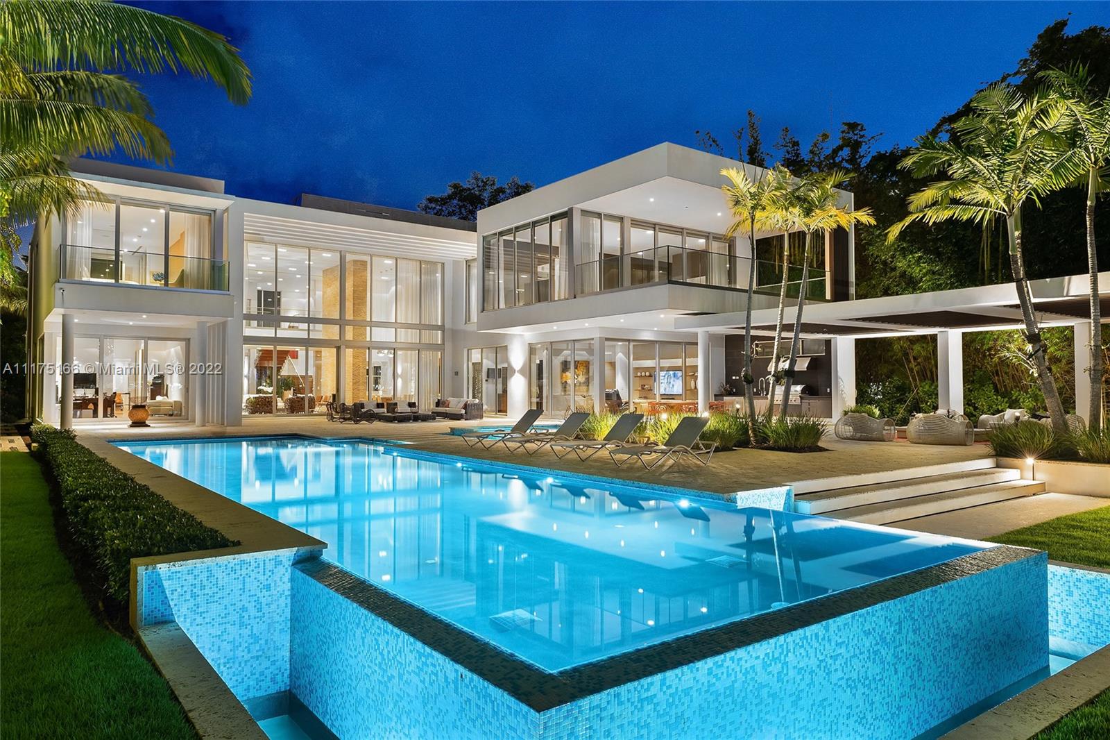This modern 2-story estate on guard-gated Palm Island was magnificently redesigned and sits on a manicured 32,000 SF lot w/100' of waterfront & 13,144 total SF. The home features 9BR/8+1BA, soaring ceilings, rich hardwood floors & expansive living, dining & family areas all with stunning water and city views. A gourmet kitchen sports top-of-the line appliances, a family room, a movie theater, elevator, pet room, 4-car garage, staff rooms, recreation room and a full gym. The 2nd floor principal suite is spacious w/views to the pool, dual walk-in closets and beautiful Carrara marble bathroom. Outdoor features include a large pool w/Jacuzzi, covered seating area with summer kitchen, an IPE wood dock & direct access to Biscayne Bay & the Ocean. Being sold furnished.