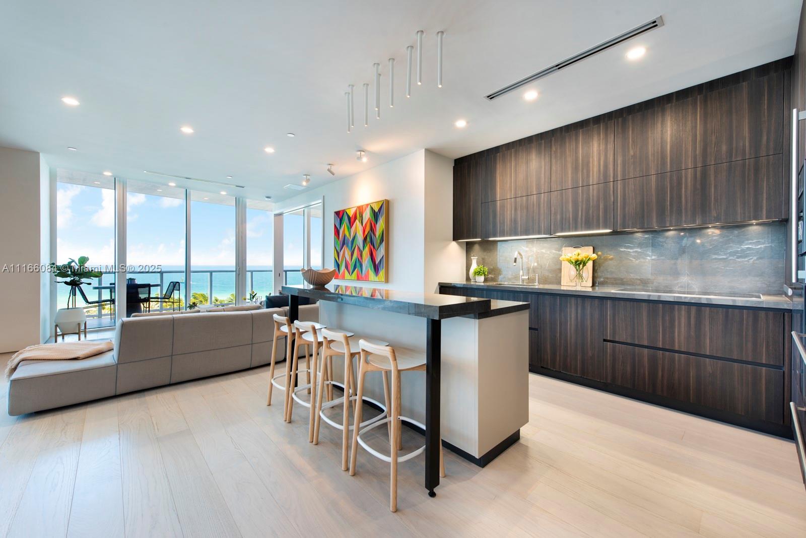 Influenced by the surrounding sand and ocean, this newly redesigned Continuum residence offers a unique open split floor plan and sweeping ocean views from every room. The light oak wood floors, gorgeous B&B Italia furnishings, designer lighting fixtures, and serene decor bring the outdoors inside, making this move-in-ready unit the ideal beachfront residence. A private elevator foyer, built-in closets, remote control shades and blackouts, and dimmable lighting take comfort to new levels. The stylish kitchen by Poliform features, stainless steel Miele appliances, a Sub-Zero refrigerator, and marble countertops. Luxury amenities include beach access and service, Patio Pavilion Restaurant, The Sporting Club, three tennis courts, swimming & lap pools, and indoor & outdoor fitness facilities.