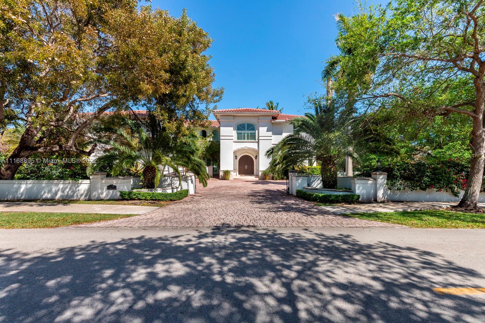 Enjoy Pinecrest living at its finest in this 6 bedroom, 7 bathroom gated estate located on a 40,336 SF corner lot. Upon entering you will be greeted by bright, natural light, a wood-burning fireplace, and soaring 22 ft ceilings that lure you out to a covered terrace and pool area. The primary bedroom features two large walk-in closets and private terraces that overlook your luscious backyard. Other features include: 3-car garage, high-impact windows, and doors, and a partial home generator.
