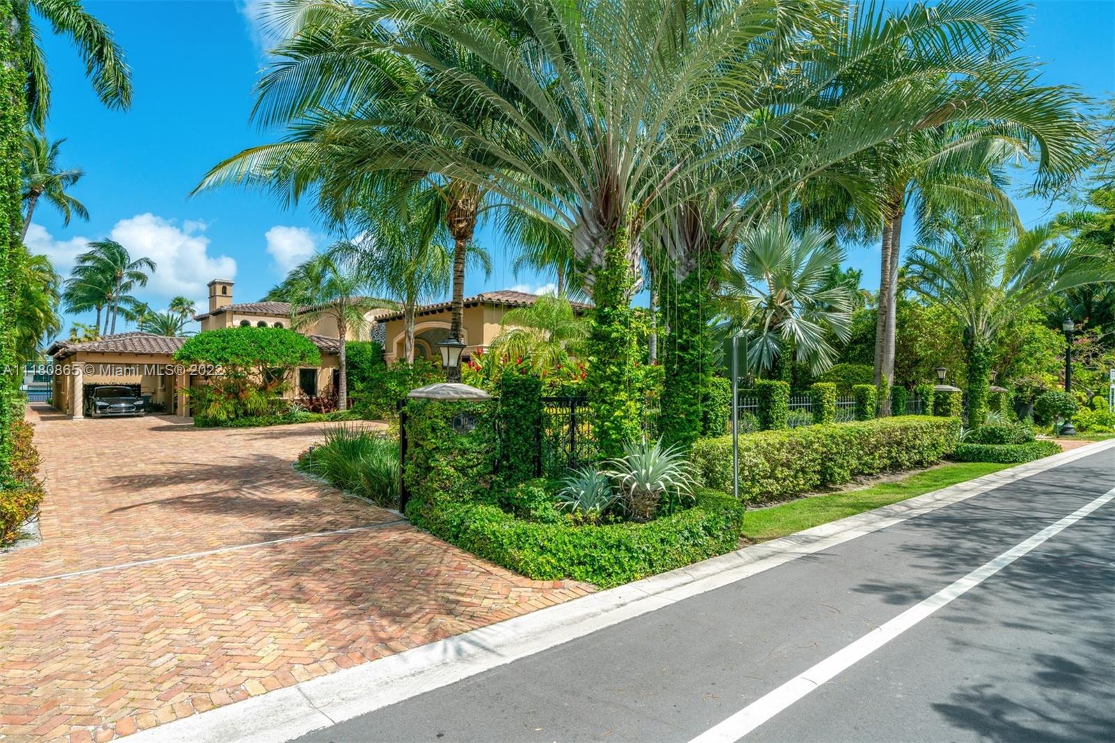 Very special Mediterranean waterfront estate on exclusive, guard-gated Palm Island w/100 ft of water frontage, floating dock, 2 boat slips w/lifts & no bridges to the ocean. 30,000 SF of lushly manicured landscaping surround the home. Totally rebuilt in 1998. 6BR/6.5BA w/wrought iron gated entry opening to a trompe-l'oeil painted porte-cochère & dramatic 35’ entry vestibule w/water views. Exquisite artisan details abound throughout. Enjoy indoor/outdoor living & entertaining from light-filled rooms opening onto covered terraces overlooking a one-of-a-kind tiled pool & waterway. All rooms have voluminous ceilings including living room & large master suite, formal dining, eat-in kitchen, gym & staff quarters. Tesla charging station. Palm Island offers a nearby community park & tennis courts.