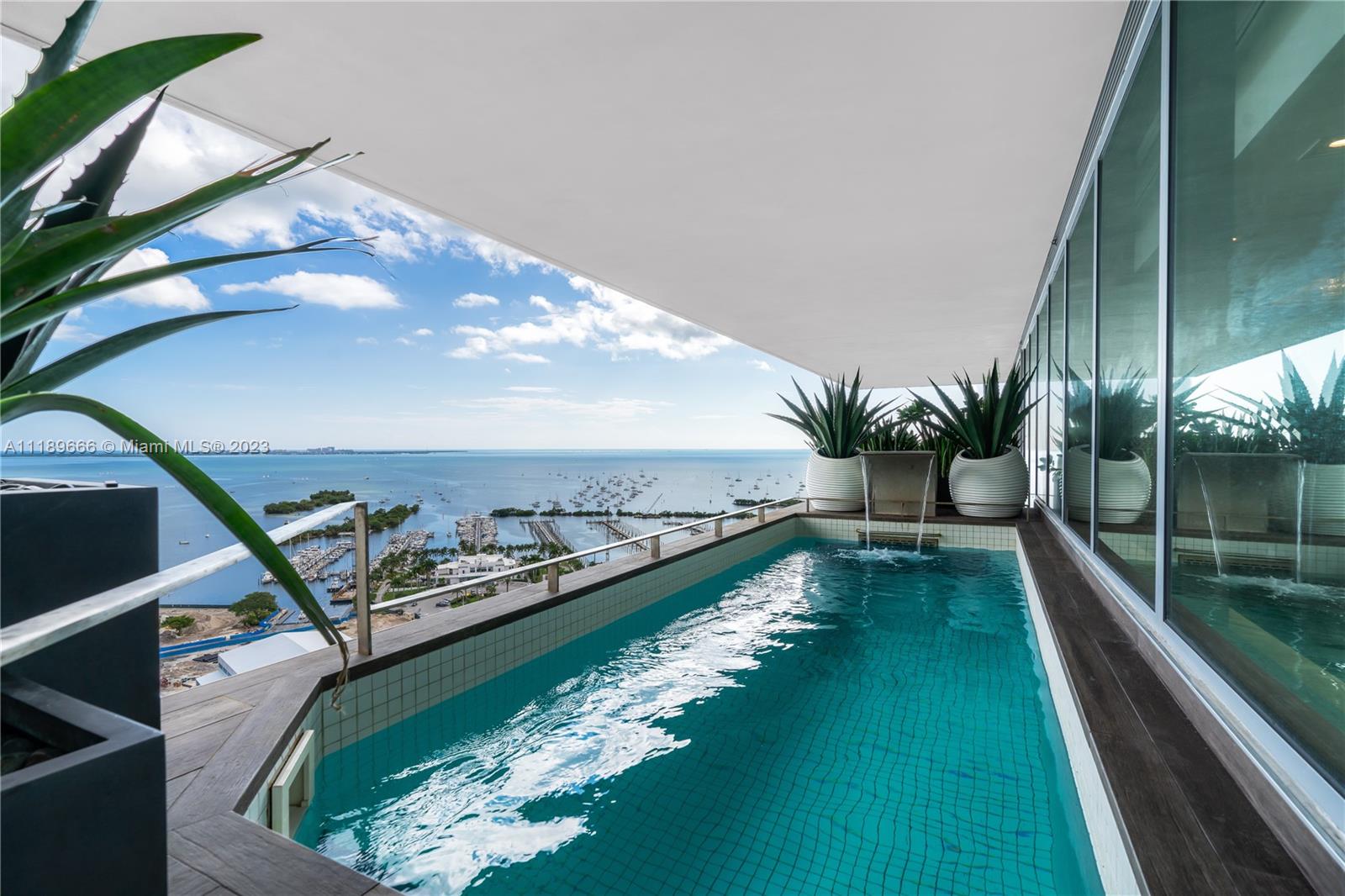 In the heart of Coconut Grove, footsteps away from couture shopping and exquisite dining sits this magnificent, fully-furnished 10,180 square foot penthouse in the sky. Surrounding this generous living space is an expansive veranda, capturing majestic views of Biscayne Bay. Renowned, award-winning designer, Steven G, created exquisite spaces throughout this substantial home in the sky, including 6 bedrooms, 7.5 bathrooms, 2 offices, a bar, a wine cellar, entertainment space, and much more, including a private plunge pool and a 4 car private garage. A unit you’ll have to see to believe.