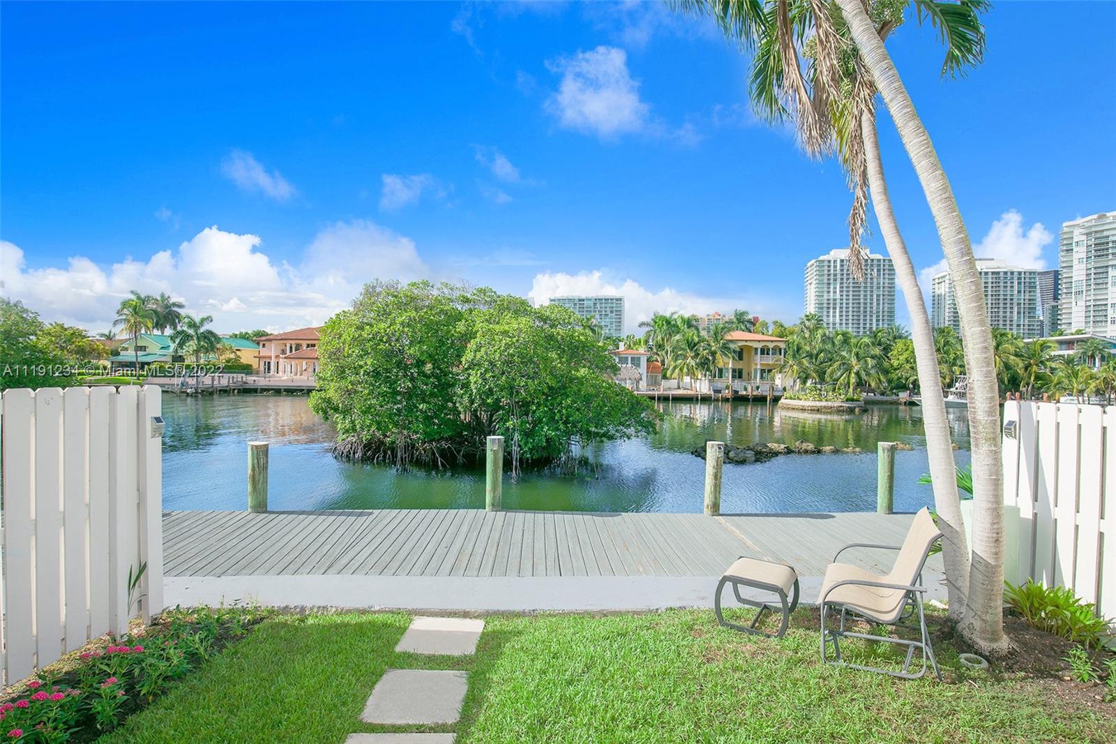 Come see this Hidden Gem in gated private island community, just few steps to the Beach. This 2,735 sqft waterfront Custom-Designed townhouse with Multi-Million Dollar views, features Entertainer's dream kitchen with Huge Bar, European white gloss cabinets, High-End Stainless Steel appliances, Designer quartz countertops/backsplash, Wall Oven & Glass Cooktop. Open concept Living/Dining/Family area features 32X32 Porcelain tile floors, Decorative dropped ceilings with LED lighting, Wood accent wall, High impact sliding doors and Glass staircase railings. Renovated bathrooms with Double Vanities, Glass enclosed shower, Large jacuzzi tub. Walk-in closets in every bedroom. Master bedroom has two custom-built closets. Newer AC & Water Heater. Dock available! True Boater's paradise!