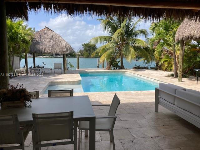 Waterfront paradise. Walking distance to the beach. Walking distance to Surfside, restaurants and stores. Boat lovers with private deck. Heated pool. The house has been renovated with impact windows, new AC, and furnished, Ready to move in!  Easy to show