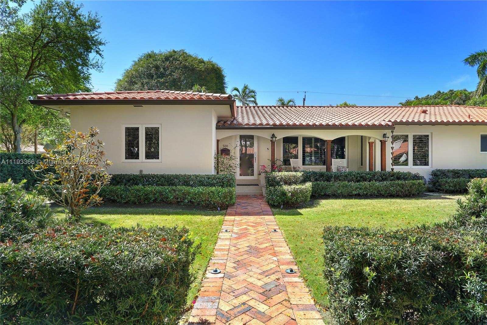 Absolutely impeccable 3 BR, 3.5 BA + office, 2,733 SF home on a 12,500 SF lot, situated on the prettiest street in Coral Gables!  A true classic, the beautiful covered front porch leads to a foyer entry, formal living & dining rooms, and sunny family room overlooking a long covered patio and the lush, private lawn, complete with its own putting green!  The spacious kitchen has fresh, white cabinetry, stainless steel appliances, pantry, & eat-in area.  3 large bedrooms each feature their own en-suite bathroom, and are situated privately away from one another, & there is an additional office with its own half bath.  Beautiful, newly-refinished wood floors, original moldings, hurricane impact glass throughout, 1 car garage, & more just 1 block from all that downtown Coral Gables has to offer!