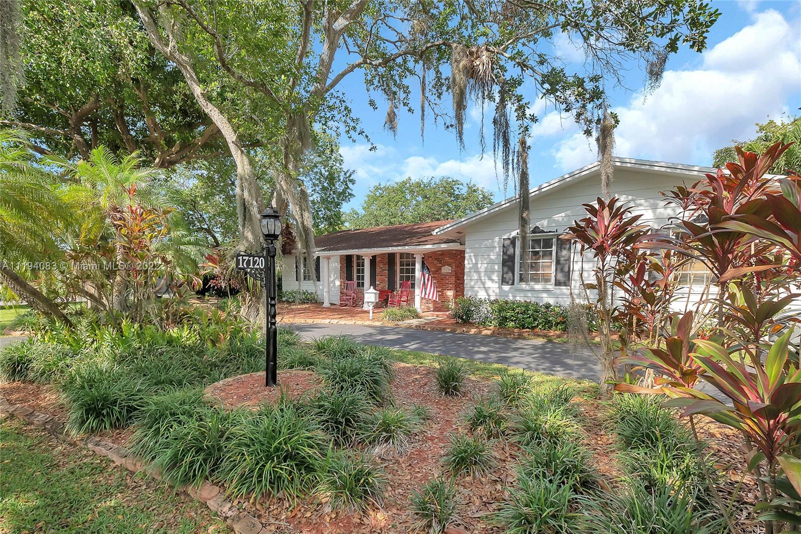 Charming colonial style, 3 bedroom/ 2 bathroom canal front home in Palmetto Bay. Formal living and dining rooms. Kitchen features wood cabinetry, granite counter tops, stone backsplash eat in breakfast area. Family room has accent brick wall, wet bar and sliding glass doors out to the pool. Lovely master suite with walk in closet , master bath has dual sink vanity and shower. Tile and laminate flooring. Wonderful fenced,  tropical landscaped yard with deep covered patio and pool. Circular driveway, 2.5 car side entry garage.