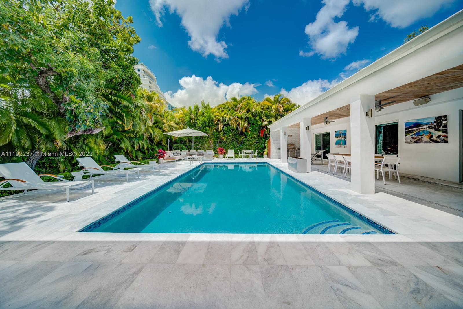Enchanting modern contemporary residence in Miami’s upscale neighborhood, Bay Point Estates. The beautiful home, at the end of the cul-de-sac, sits on an oversized 16,988 sf lot offering immaculate lush landscaping. The NW end features a heated saltwater pool, & Calcutta deck with bbq area & rich greenery, while the SW end encompasses a 5,000 sf Zen Garden & koi pond leading to a brick path & bountiful Canopy trees. Indoors, the new owners can find an impressive master suite with a balcony, 3 more bedrooms, 3 baths, a large entertainment room & second living room, stunning kitchen with gas island and top of the line finishes, new AC & gas generator, and 2 car garage. The gated community of Bay Point Estates is just minutes from Miami's most famed shopping, dining, and top rated schools.