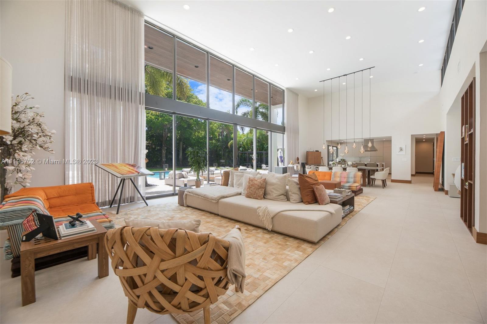 Let The Sun Shine in at this unique residence in North Pinecrest. The home has 4 bedrooms w. custom-made walk-in closets & private baths. The living areas are plentiful & host large gatherings. The custom-designed bar w.a Subzero cooler provides a richly textured backdrop for entertainment. The kitchen boasts a Wolf dual fuel range w. hood, microwave, Sub Zero refrigerator & freezer. 2 oversized kitchen islands & high-wide custom-made sliding glass doors lead to stunning outdoor areas. The terrace, pool, & summer kitchen are ideal for gatherings. Nestled on an acre lot in a park-like setting w. abundant flora & fruit trees. You are cordially invited to visit this show stopper *Living area 3,989.60 Sqft Entry 125.30 Sqft Garage 555.00 Sqft Real porch 498.45 Sqft Total Area 5,168.35 Sqft*