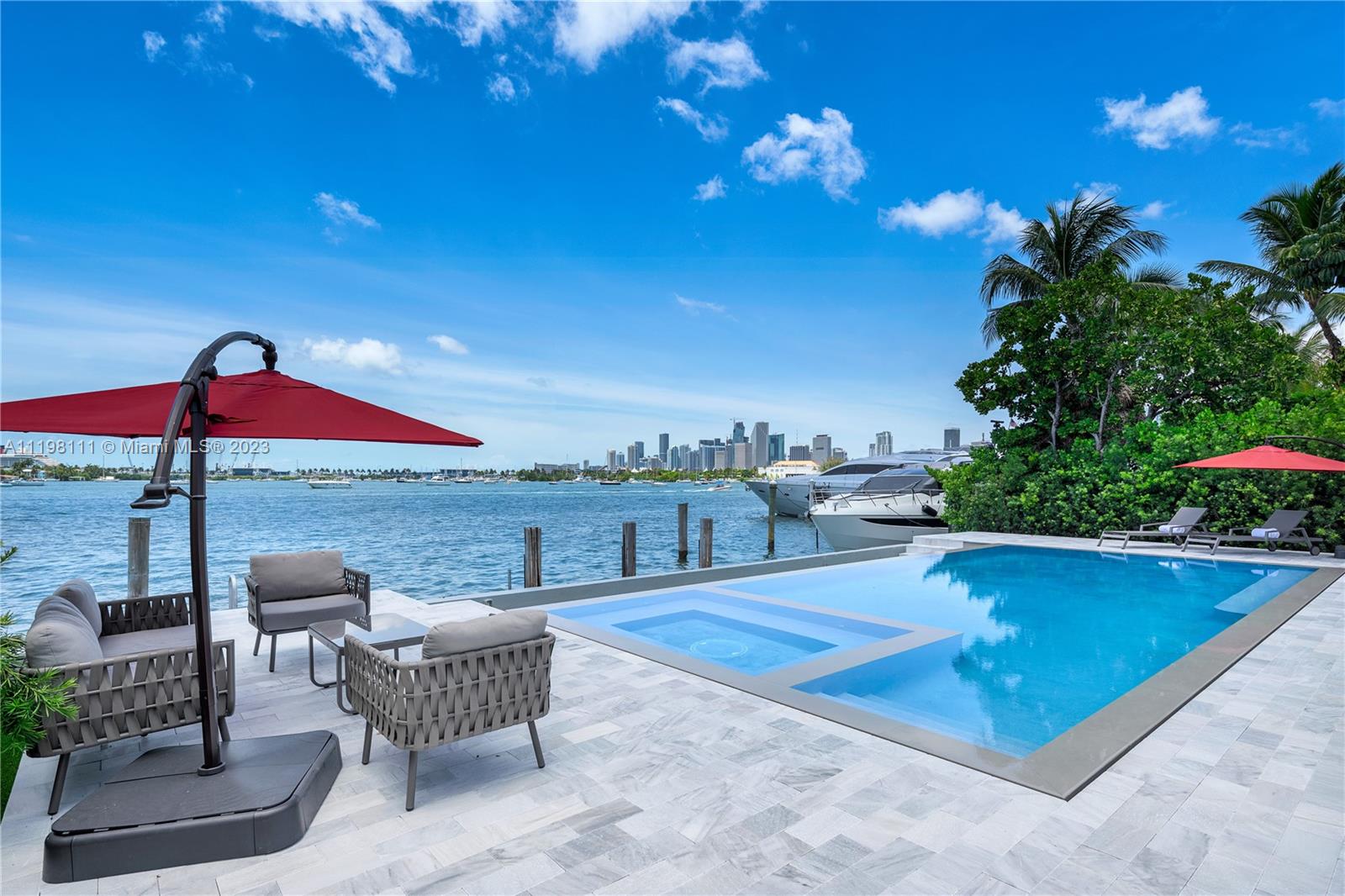 Step Inside With Me! Live the ultimate Miami lifestyle with stunning unobstructed water and Skyline views on the Venetian Islands. This Southern facing beauty is a boater's dream with 70 FT of water frontage and direct Bay access. Situated on an expansive 12,250 SF lot and recently renovated, this home features 6 bedrooms with tile and oak plank wood flooring throughout. The oversized eat-in kitchen is finished with Wolf appliances and marble countertops. The open living area is complete with a bar and sweeping bay views. Wake up and walk out onto the primary suite's oversized balcony to take in the gorgeous Miami weather. This home is made for entertaining with an outdoor summer kitchen, infinity pool, and plenty of outdoor lounging.