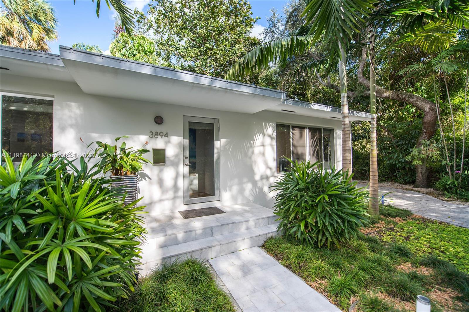 Lovely home on a great street in lush, tree-canopied S. Coconut Grove. Walk to the Grove villages galleries, boutiques, cafes and bayfront parks & marinas. Totally renovated and expanded in 2013 includes new roof & impact glass throughout. Light-filled living spaces w/ wood floors and 10 ft ceilings, overlook the covered patio for year-round outdoor entertaining. Large master suite has walk-in closet, modern-style bath w/oversized shower and French doors opening to the garden. Euro-style kitchen features Italian teak cabinetry, stainless steel counter-tops & breakfast bar. Light-filled family room w/ wood floors & 10 ft ceilings, overlooks the covered patio for outdoor entertaining. Not in a flood zone. Just mins to highly rated schools & to shopping & dining in South Miami & Coral Gables.