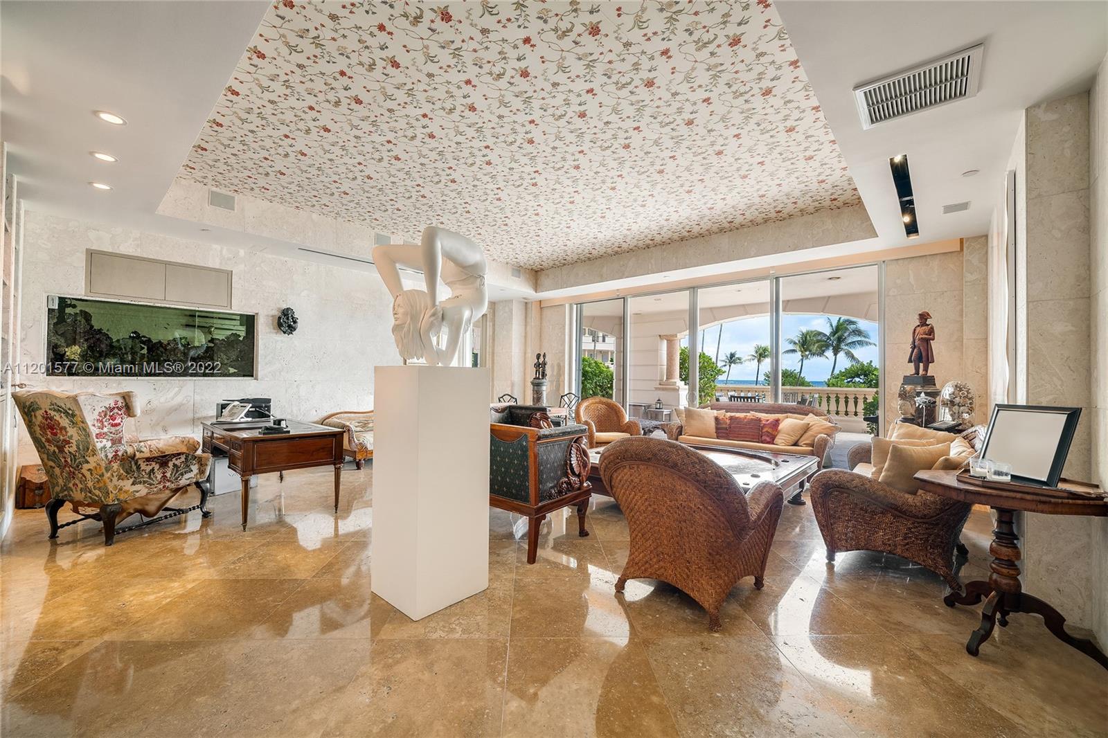 This one-of-a-kind 5BR/6+2BA ground floor townhouse is truly like no other on Fisher Island. The 2-story unit boasts 6,268 SF of luxury w/stunning custom finishes, coquina stone walls, exquisite marble floors & expansive ground floor terrace plus 2nd floor terrace both w/mesmerizing views of the beach & ocean. The principal suite is spacious, beautiful principal spa bathroom, adjacent family room, den/office & 2 additional bedrooms each w/full baths. The second level is accesses by an elegant stone/glass staircase & features a spacious formal living & dining rooms w/ terrace access & direct ocean views, chef’s kitchen w/top-of-the-line appliances, staff quarters & large guest suite. Your private beach awaits outside your home. 5-Star Fisher Island amenities complete this amazing offering.