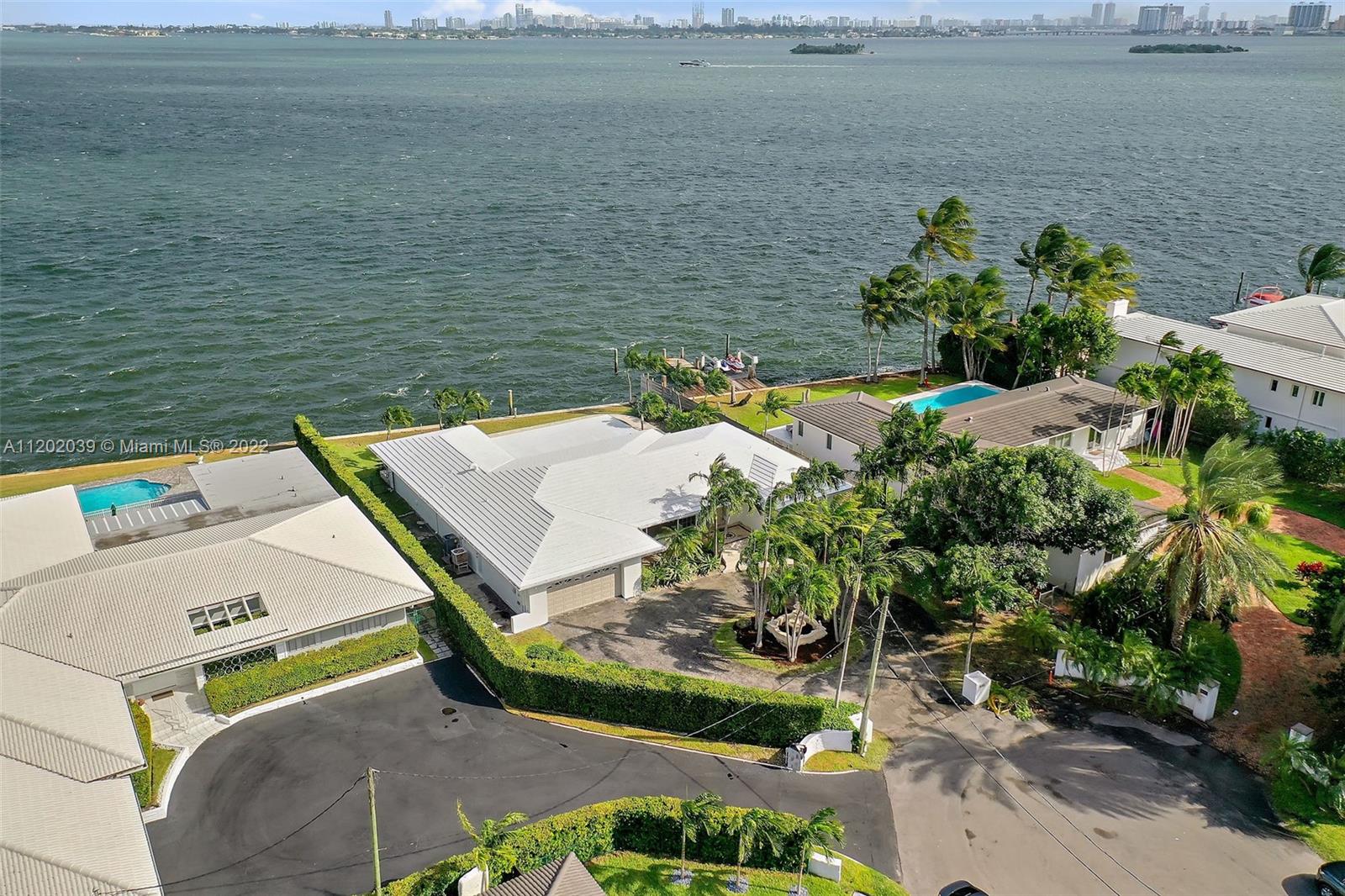 This home delivers Iconic Old Florida living on the open Biscayne Bay in red hot Village of Miami Shores. Located on a spacious lot w/ dramatic bay views facing East for striking sun rises & sunburst sunsets overlooking the blue waters of the Biscayne Bay! The open & sprawling interior floor plan creates an expansive flow of the living area. Covered outdoor deck perfect for entertaining guest both inside & out. Pool home w/views of the bay All bedrooms are en-suite plus an additional half bath "powder room" for guests. The master BR is situated off the backyard w/striking views of the pool & bay. 2nd & third bedroom suites are on the opposite wing creating privacy for kids & guests. Full amenity family driven community w/ a Village Council, Country Club, Tennis, Police Dept.,