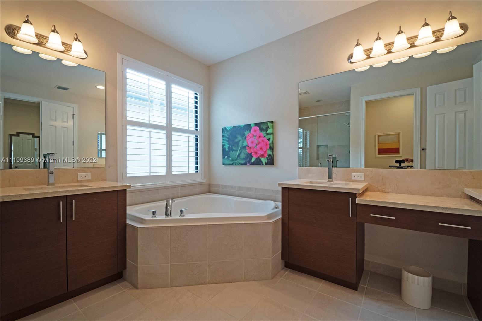 Master Bathroom with double sinks, jacuzzi bathtub, makeup counter/lights, lots of cabinetry