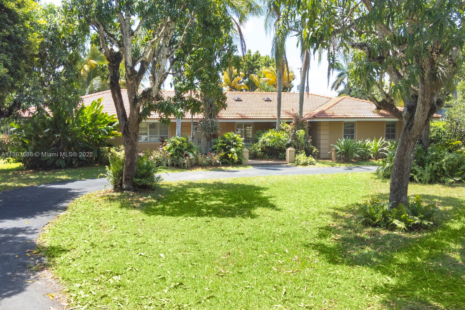 Sought after and rarely found 5-bedroom family home on an oversized half acre lot on quiet no traffic North Pinecrest street. Split plan, tile roof, enlarged wood kitchen, wood flooring in bedrooms, 2 skylights.  Great layout with 2-car garage, deep pool, large cantilevered overhang (no columns) , big yard and privacy.  Hurricane shutters throughout (some impact glass windows) , flood zone "x" so no flood insurance required.  Pinecrest Elementary.