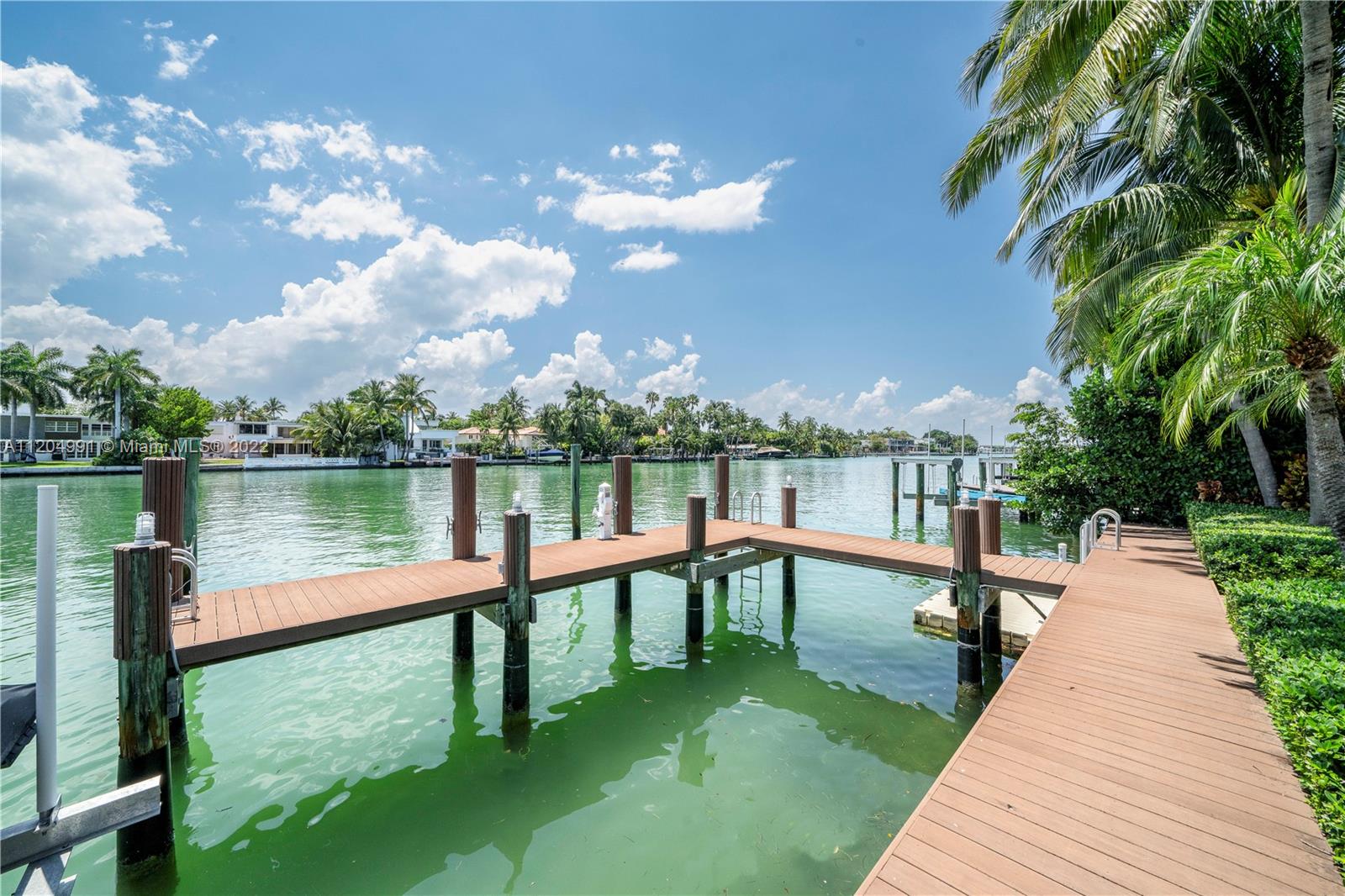One of Miami's most sought-after waterfront islands! Sunsets & sweeping wide water views from this west facing modern Mediterranean home on private gated Allison Island. Newly renovated, move-in ready, 5,600SF w/ 6BD, 6.5BA on a 16,200SF lot w/ 75FT of yacht friendly deep water & direct bay/ocean access. Great floorplan w/5BD on 2nd floor all w/en-suite baths, walk-in closets & terraces. 3 sitting rooms, mud room, gym, 2-car garage, fully equipped kitchen w/double islands, wine fridge, Miele appliances, laundry & separate pantry w/maids quarters. Crestron system w/built in speakers, updated dock & jet ski lift. Generous enclosed front yard & expansive backyard w/ an oversized mosaic tiled saltwater heated pool w/spa, covered summer kitchen & mature landscaping to ensure ultimate privacy.