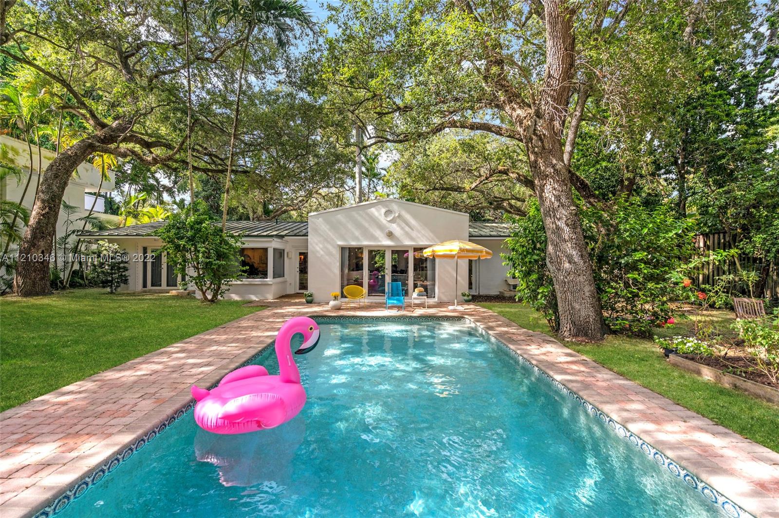 Coveted mid-century 4 bed / 3.5 bath pool home on a magnificent 19,700 sq ft lot in the heart of Coconut Grove. Enjoy serenity & privacy among majestic oaks, fruit trees, and the sounds of native birds, just minutes from downtown Miami. Located on lushly green Poinciana Ave, this gated sub-tropical paradise retains the bohemian ambience that’s attracted artists, musicians and writers to The Grove for decades. Occupied by current owners since 2004. Recently painted and refreshed. Galvalume metal roof. Two-car garage with Tesla charger installed. Under a mile to top schools, houses of worship and nature preserves. Marina, playgrounds, playing fields, farmers market, cafes and foodie-favorite restaurants are all within easy biking distance. Priced to sell & ready to show. Request our 3D Tour.
