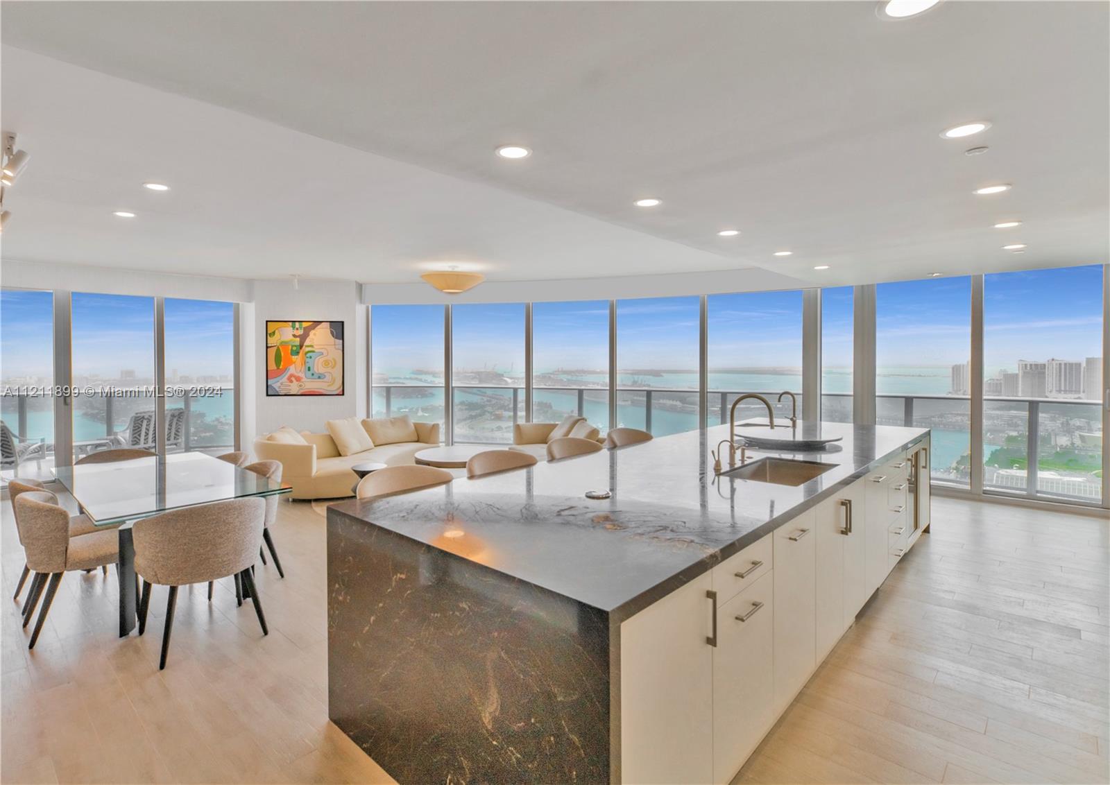 Unobstructed views of the bay, Ocean, and Miami Skyline. 3 Bed + Den | 4 Bath (2,365 of interior sq. Ft). Hundreds of thousands of dollars in upgrades. Tastefully furnished with the best brands including Roche Bobois, Minotti, and Holly Hunt furnishings (Over $300k). See Attachments.  No expense was spared and no detailed overlooked.  Custom-built kitchen (not standard developer unit) with a mini-bar area with Sub-Zero under-counter refrigerator and freezer drawers, 2 Sub-zero wine coolers, a Sub-zero refrigerator, a french door GE Oven and more, plus interior doors upgraded to Lualdi Italian doors (By Piero Lissoni), 2 Toto Neorest Toilets, wired-in electric window treatments, California closets, custom vanity, Paris Mirrors with Led lighting, and much more.
