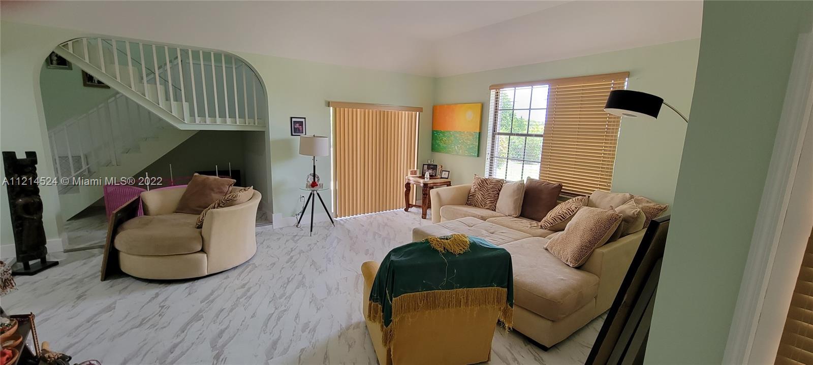 Sunken living room with slide doors out to balcony patio