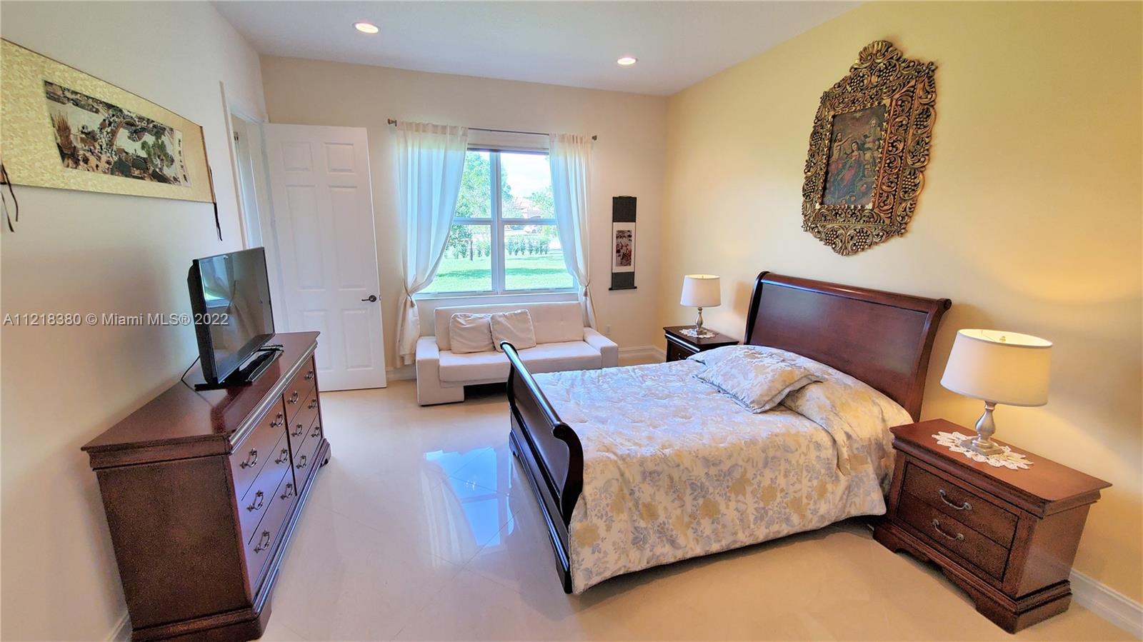 Large 2nd bedroom with spacious walk-in closet and porcelain flooring as whole house