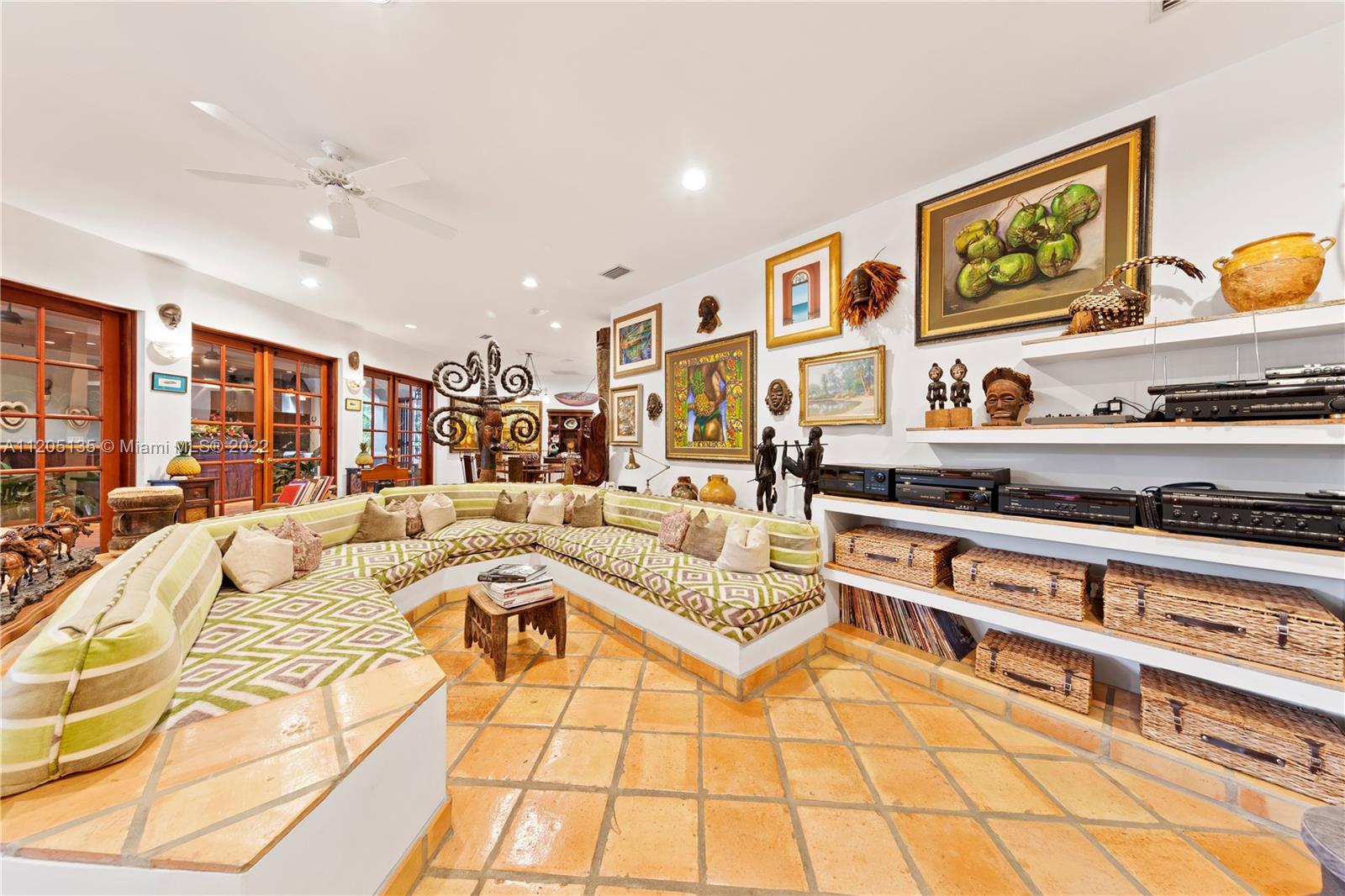 Another view of family room, the kitchen table is visible in the distance, all opening to outside lanai, bar/ summer kitchen, etc. Ideal for combining the interior and exterior spaces. The main kitchen is adjacent to the kitchen table. The estate has great movement with the ease of flow...without walls..